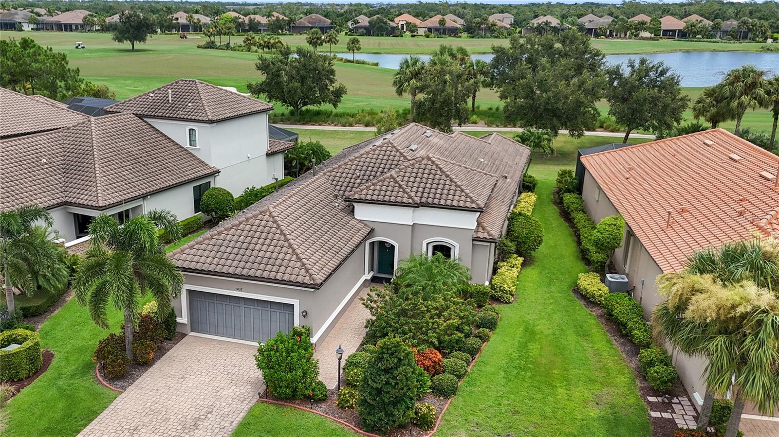 Resort-style living in Esplanade Golf and Country Club at Lakewood Ranch—America’s #1 best-selling multigenerational, maintenance free master-planned community. This gorgeous Farnese model is light and bright, spacious, and truly move-in ready, offering 2 bedrooms + den, 2.5 baths, and a rare 3-car tandem garage. Direct golf course home. Golf-deeded ownership conveys VIP membership with priority tee times. Set on a premier homesite with spectacular water and dual fairway vistas of the 2nd and 17th, the home blends designer finishes with effortless indoor–outdoor living. The gourmet kitchen showcases GE Café stainless appliances including a natural-gas cooktop with vent hood, elegant quartz countertops, a huge island, and a glass-tile backsplash. 12' foot tray ceilings throughout. Triple and double sliders open to an expansive, fully enclosed, screened lanai with a summer kitchen—your private retreat for morning coffee or sunset cocktails. The den features French doors and plantation shutters. The generous owner’s suite offers bay windows, a tray ceiling, and a large spa-style bath with stone countertops, double sinks, a walk-in shower, a spacious custom California Closet with safe, and a private water closet. The guest bedroom enjoys a full en-suite bath with a soaking tub. Formal dining room, powder half bath and laundry room round out the living area. Other enhancements include solar tubes that brighten the space and hurricane shutters for enhanced storm protection and peace of mind. 18-hole championship golf course, every day feels like a vacation! Enjoy two stunning clubhouses, resort pools and hot tubs, fire pits, waterside veranda, fitness centers and classes, activities director with events and live music, pickleball and tennis, driving range and putting green, bocce, playground, dog park, spa and hair salon, Culinary Center, and the Barrel House Bistro—full restaurant and bar with wraparound patio to the 18th fairway—plus the Bahama Bar & Grill at the main pool. Guard-gated and ideally located minutes to UTC, Waterside, SRQ, St. Armands, and the beaches of Lido, Siesta, Anna Maria, and Longboat Key. Priced to sell—best value on the golf course with golf-deeded membership. Quick closing available. Offered at $949,000. Schedule your private showing today.