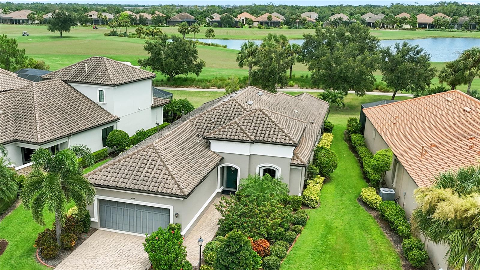 Resort-style living in Esplanade Golf and Country Club at Lakewood Ranch—America’s #1 best-selling multigenerational, maintenance free master-planned community. This gorgeous Farnese model is light and bright, spacious, and truly move-in ready, offering 2 bedrooms + den, 2.5 baths, and a rare 3-car tandem garage. Direct golf course home. Golf-deeded ownership conveys VIP membership with priority tee times. Set on a premier homesite with spectacular water and dual fairway vistas of the 2nd and 17th, the home blends designer finishes with effortless indoor–outdoor living. The gourmet kitchen showcases GE Café stainless appliances including a natural-gas cooktop with vent hood, elegant quartz countertops, a huge island, and a glass-tile backsplash. 12' foot tray ceilings throughout. Triple and double sliders open to an expansive, fully enclosed, screened lanai with a summer kitchen—your private retreat for morning coffee or sunset cocktails. The den features French doors and plantation shutters. The generous owner’s suite offers bay windows, a tray ceiling, and a large spa-style bath with stone countertops, double sinks, a walk-in shower, a spacious custom California Closet with safe, and a private water closet. The guest bedroom enjoys a full en-suite bath with a soaking tub. Formal dining room, powder half bath and laundry room round out the living area. Other enhancements include solar tubes that brighten the space and hurricane shutters for enhanced storm protection and peace of mind. 18-hole championship golf course, every day feels like a vacation! Enjoy two stunning clubhouses, resort pools and hot tubs, fire pits, waterside veranda, fitness centers and classes, activities director with events and live music, pickleball and tennis, driving range and putting green, bocce, playground, dog park, spa and hair salon, Culinary Center, and the Barrel House Bistro—full restaurant and bar with wraparound patio to the 18th fairway—plus the Bahama Bar & Grill at the main pool. Guard-gated and ideally located minutes to UTC, Waterside, SRQ, St. Armands, and the beaches of Lido, Siesta, Anna Maria, and Longboat Key. Priced to sell—best value on the golf course with golf-deeded membership. Quick closing available. Offered at $949,000. Schedule your private showing today.