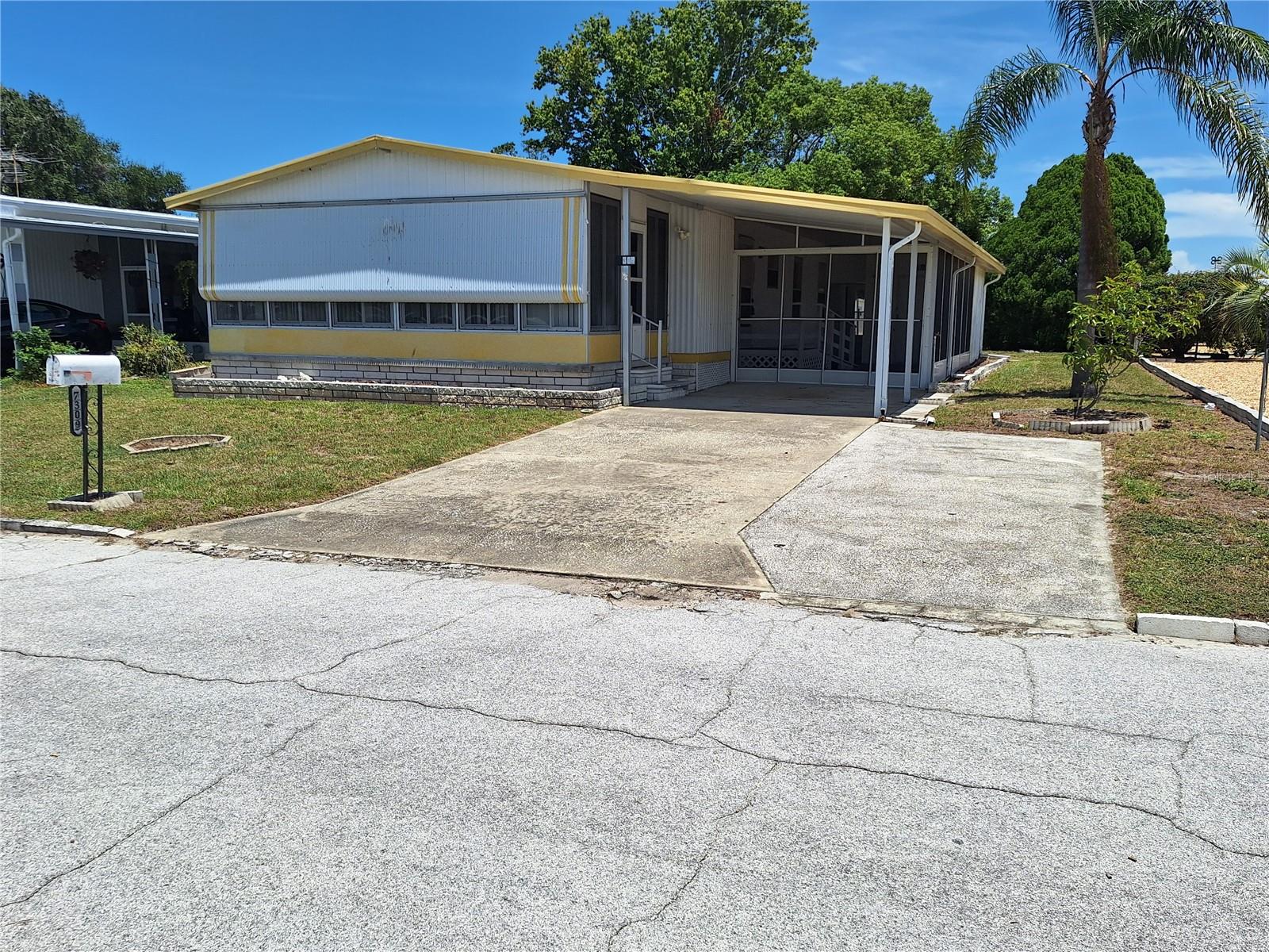 What a Lakefront Dream Retirement or Vacation Home this will make! In a Park where you must be 55 or older, and sitting on your own deeded lot, is where you will enjoy countless days in the shade overlooking the lake! This tastefully updated home has a long Driveway, a Screen Enclosed Patio, Sliding Doors leading out to a 23 ft Enclosed Lanai with Vinyl Windows. The minute you enter you feel the bright updated quality of the home. It has Lovely Laminated Flooring throughout, a Large Primary Suite offering a Walk-in-Closet and a nicely done Bathroom. A great home for entertaining with it's Open Floor Plan. The Kitchen has had updates too and shows real nicely. The Dining area has a Built in Hutch to help store your Fine China! There is a Wheelchair Ramp in place right now, but the permanent concrete steps are underneath and match the front steps. Out back, you are going to enjoy your coffee in the morning shade on one of 2 patios out back along the Lake. This has a big lot for being in a Mobile Home Park sitting on almost 0.19 Acres! Ponderosa Park offers a very affordable way to be in a Park, on your own Deeded Lot, that has it's own Clubhouse and Pool for the over 55 age group, and only a cost of 250.00 per year! Come make this your next great place to call home and dip your fishing pole in the water.