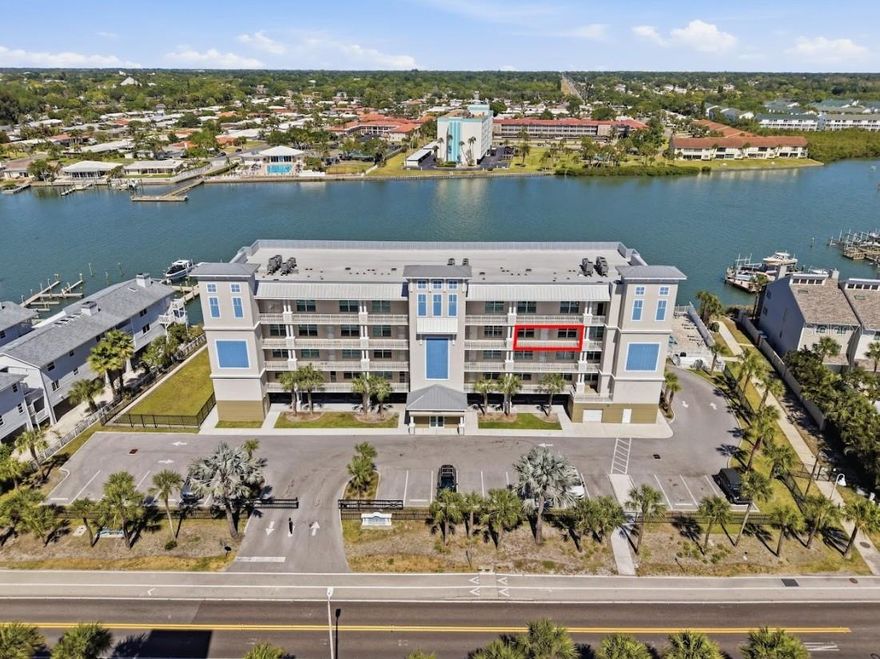 Discover elevated coastal living at The Anchorage, a gated waterfront community completed in 2022 along more than 220 feet of beautiful Intracoastal frontage in Indian Shores.
This professionally designed 3-bedroom, 2-bath residence offers the perfect blend of modern luxury, coastal elegance, and effortless beach access just across the street.
Inside, the bright open floor plan is enhanced by coastal plank ceramic tile flooring, refined finishes, and thoughtfully curated designer details throughout.
The spacious living and dining areas flow seamlessly to an expansive 30-foot-wide waterfront balcony, creating an ideal setting for morning coffee, sunset cocktails, or outdoor dining overlooking the water.
The sophisticated kitchen is both stylish and functional, featuring stone countertops, GE Café stainless steel appliances, under-cabinet lighting, and abundant workspace for entertaining.
Custom touches including faux wood beam accents, decorative wall detailing, designer lighting, and upscale treatments add warmth and character to the home.
The primary suite is a peaceful waterfront retreat with direct balcony access and wide water views.
Its spa-inspired bath features dual sinks, stone countertops, and an oversized walk-in shower with frameless glass enclosure.
The second bedroom enjoys a Gulf-facing view, while the third bedroom offers flexibility for guests, a home office, or additional sleeping space.
Additional conveniences include in-unit laundry and extra interior storage.
The Anchorage is an intimate community of only 21 residences surrounded by lush tropical landscaping and resort-style amenities.
Residents enjoy a formal secured lobby, high-speed elevator access, heated pool and spa, grilling and lounge area, fishing dock, and gated entry.
This residence also includes two reserved parking spaces, one under the building and one in front.
A park area nearby offers a pleasant green space for a stroll, while the Gulf beach is only steps away.
With a 30-day minimum rental policy allowing limited short-term use, this is an exceptional opportunity for personal enjoyment or seasonal coastal living.
Refined, relaxing, and perfectly positioned between the Intracoastal and the Gulf, this Indian Shores residence captures the very best of waterfront living.