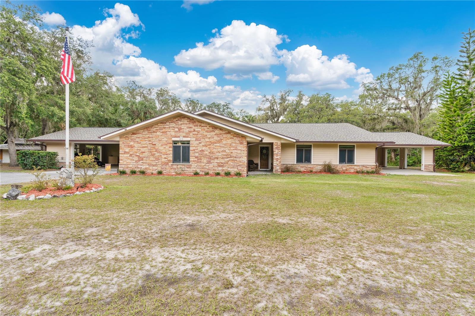 Tucked along a peaceful, shaded forest path and set on 5.46 acres of pristine St. Cloud land, this multi-unit gem offers a rare blend of luxury, function, and versatility that’s perfect for multi-generational living or income potential. The beautifully maintained main home features a desirable split floor plan with two expansive master suites, a spacious family room with a charming brick faux fireplace, granite countertops, 42" cabinetry, and a large formal dining area ideal for entertaining. A newer, high-efficiency HVAC system, fully paid-off solar panels, and a NEW roof which provides peace of mind and energy savings. Step outside to your own backyard oasis, complete with a brand-new ionized PebbleTec pool, twin carports, and a private outdoor living area. Work from home in the detached office suite with a full bathroom, or accommodate guests in the fully equipped in-law unit featuring vaulted ceilings, a luxurious kitchen, open-concept living, and a wraparound patio perfect for enjoying Florida’s breezy afternoons. Massive garages offer space for all your toys, tools, and recreational gear. This one-of-a-kind property offers a lifestyle of comfort, space, and endless possibilities—schedule your private showing today!