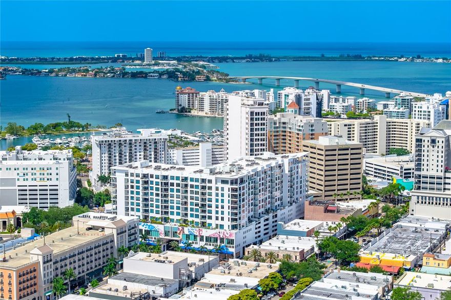 Experience elevated urban living in this spectacular penthouse residence at The Mark in the heart of downtown Sarasota, showcasing sweeping views of the city skyline, Sarasota Bay, and the Gulf of Mexico, this home blends sophisticated design with luxurious comfort. Thoughtful upgrades include custom lighting and automatic window shades throughout. Voluminous ceilings, 24" white porcelain floors and expansive windows create a bright and inviting atmosphere. The open-concept floor plan is designed for effortless entertaining, featuring a gourmet kitchen w/Jenn Aire appliances, spacious dining area, and elegant living room that opens to an oversized private terrace complete with a summer kitchen and electric grill. The primary suite offers two generous walk-in closets and a spa-inspired bath with a deep soaking tub, dual vanities, a glass-enclosed water closet, and a separate glass-enclosed shower. Both the primary and guest bedrooms enjoy water views. Two parking spaces within the private attached garage. The Mark offers exceptional amenities including 24-hour concierge service, state-of-the-art fitness center, resort style heated saltwater pool and spa, club room w/catering kitchen, fireplace, billiards and more. Located within close proximity to Whole Foods, Restaurants, cultural venues, art galleries and Bayfront Park.