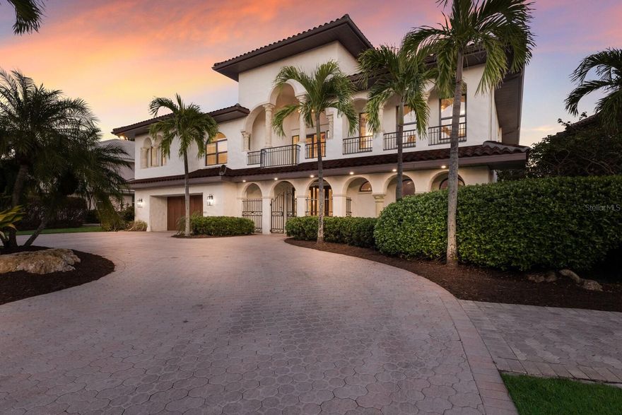 One or more photo(s) has been virtually staged. Stunning Waterfront Home on Siesta Key with Spectacular Bayou and Bay Views. Welcome to this exceptional waterfront property located on the serene and sought-after Siesta Key. Situated on a quiet dead-end street, this gorgeous home offers breathtaking views of the bayou and open bay, along with direct access to protected sailboat waters, just 100 yards from the open bay. With a 16,000lb boat lift, you'll have the perfect setup for boating enthusiasts. This expansive residence boasts 3,400 square feet of luxurious living space upstairs and an additional 2,000 square feet of air-conditioned space downstairs (currently used as storage). Built with concrete block construction and impact windows, this home offers both durability and peace of mind. Step inside to discover a spacious, open-concept living area featuring beautiful real wood floors throughout. The gourmet kitchen is a chef's dream, equipped with an 8-burner gas range, double ovens, and top-of-the-line appliances. Perfect for entertaining, the kitchen flows into the living and dining areas, all of which offer panoramic water views. 
The oversized primary suite is a true retreat, offering ample space, stunning views, and a spa-like ensuite bathroom. A private den/office provides a quiet place for work or relaxation. The home also includes vaulted, beamed ceilings that add character and elevate the airy feel of the living spaces. Enjoy the Florida lifestyle with your own outdoor oasis, featuring a heated saltwater pool and spa, ideal for year-round enjoyment. The upstairs front balcony provides a perfect spot to unwind and take in the spectacular sunsets over the water. With an elevator for added convenience and tons of storage throughout, this home combines functionality with luxury. Located just minutes from Siesta Village and the world-famous Siesta Beach, you'll have access to vibrant local dining, shopping, and the best sandy shores on the Gulf Coast. Don’t miss the opportunity to own this incredible waterfront property on Siesta Key, where every detail has been thoughtfully designed for comfort, style, and waterfront living at its finest.