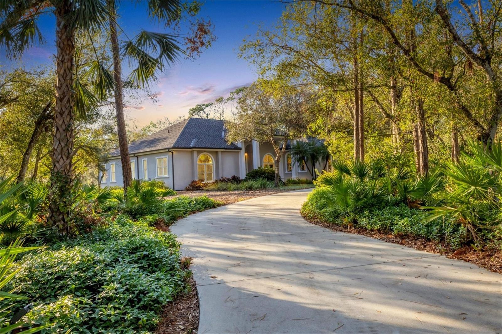 Looking for peace, privacy, and natural beauty? You’ve found it! Nestled on 6 serene, treed acres, this stunning contemporary home, built with top-tier craftsmanship, offers the perfect blend of modern comfort and breathtaking surroundings. Low-maintenance landscaping and a circular concrete driveway with ample guest parking set the tone for this peaceful retreat. Inside, the versatile floor plan allows for flexibility, including the potential for an in-law suite. Expansive windows flood the home with natural light, offering inviting views of the lake, visiting deer, and lush greenery. High ceilings enhance the spacious living room, which features built-in shelving and a cozy wood-burning fireplace—perfect for relaxed evenings, with a powder room conveniently nearby. The open kitchen features both electric and gas cooking options. The dining room, subtly separated by a half-wall, creates an intimate yet open feel. French doors lead to the wide lanai, seamlessly blending indoor and outdoor living. With four distinct bedroom suites, each featuring an en suite bath, this home is ideal for hosting guests, working from home, or creating a private sanctuary. The primary suite boasts a bay window with beautiful nature and lake views, a spa-like bath with electric instant hot water, a bidet, and a separate tub and shower, along with well-planned his-and-hers closets for effortless organization. The fourth bedroom suite, currently used as a family room, includes an adjoining den/bedroom with a private entrance, making it perfect for an in-law suite or home office. The large laundry center with gas dryer offers a planning desk and pantry. You'll enjoy relaxing backyard views of the lanai, pool, and expansive green space from the kitchen, living room, dining room, and 2 bedrooms. Frequent visits from water birds and deer enhance the peaceful, natural charm. A 12x20 storage shed is tucked behind trees with its own path for access, and a separate concrete-floor fenced kennel leads to a 100' x 100' fenced dog play area, which could be repurposed for raised-bed gardening, a children's play yard, or chickens! A sturdy trellis will hold your orchids or outdoor art. Designed for easy living and peace of mind, this home features double-pane windows for energy efficiency, a Kohler whole-house generator for backup power, storage shelves and a workbench, and a gas second instant water heater for added comfort. Meticulously maintained from day one, this home is ready for you to enjoy. Imagine waking up to lake views, peaceful wildlife, and the sounds of nature--all while experiencing the comforts of a high-quality custom home on over 6 gated acres. Multiple public and private schools are available, including the Classical Academy, New Gate Montessori School, Prew Academy, Sarasota Suncoast Academy, Pine View School for Gifted Students, and Riverview High School. When will you move in?