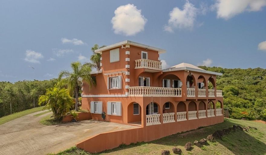 Welcome to your piece of paradise, tucked away in the countryside! Calm, quiet, peaceful space where you can relax, unwind and live out your dream.  This beautifully landscaped, fenced, rolling 2.5 acres is at the end of a road for plenty of privacy. As you enter the property a paved drive leads up to the highest point where the views open up expansively to the ocean and mountains in the distance.

This Duplex has a well appointed and unique with 2 bedrooms, 2 bathrooms and a small loft above the main bedroom, all on the main floor, with an expansive balcony that allows you to enjoy the amazing views. The state of the art kitchen has granite counter tops, newer appliances and is open to the main living area. AC in the bedrooms. Craftsman tile throughout the house flowing seamlessly from one room to the next. Very open and bright with plenty of natural light, and breezes as well, creating a natural freshness.  Downstairs boasts a one bedroom, one bath apartment with a full kitchen, indoor and outdoor living space and its own entrance, that could be used for guest or potential rental income. This apartment has its own balcony and views as well! Detached 4 car garage for cars, toys or plenty of extra storage!

Completely set up and ready for whatever might come this way. Wind generator, backup solar system, cistern that is piped into the house, storm shutters, solar hot water heater. Off the beaten path, and down a private road, this allows for quietness and privacy that you can't find in many other places on the island.

While this property is untitled, the title work has been started, which is an amazing accomplishment and opportunity.