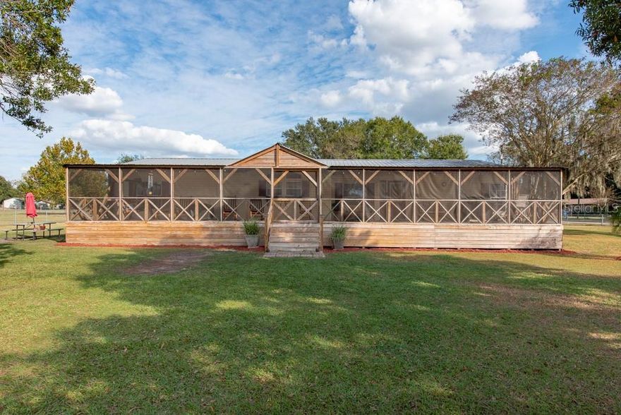 Cheers to new memories as your dream home in Plant City, Florida, is now move-in ready! This meticulously maintained 3-bedroom, 2-bathroom corner property is a true gem, offering a perfect blend of space, functionality, and style. The versatility of your living space is enhanced by the inclusion of two bonus rooms that can be easily converted into additional bedrooms and or office space. As you enter through one of the two gates, you'll immediately notice the expansive 1.24-acre lot, providing ample space for your boat, RV, or even a semi-truck. The well-manicured grounds surround a beautifully kept manufactured home with a charming presence. Step into the heart of the home, and you'll find a spacious kitchen adorned with Formica countertops, a wet bar, and a suite of kitchen appliances that stay with the property. The vaulted ceilings add an airy feel to the space, complemented by laminate wood floors throughout, except for two additional bedrooms. The master bedroom features a large custom walk-in closet with a barn door and a shiplap wall, complete with an electric fireplace for those cozy evenings. The master bathroom has been completely updated, boasting granite countertops, tile floors, all drywall, and a luxurious stand-alone tub. The hall bathroom is equally impressive, with a granite countertop and a tastefully remodeled shower. The attention to detail in these updates is evident, providing a modern and stylish touch to the home. Enjoy the Florida weather on the large screened-in front porch, added in August 2021, providing the perfect spot to relax and entertain. The entire property is securely fenced, and there's even a shed in the back, tied down and included with the home. Practical features include a recently replaced well pump in 2022, a durable metal roof, and, in preparation for unforeseen weather events, the home comes equipped with hurricane shutters tailored to each window, conveniently stored in the shed. The attention to detail and proactive maintenance make this property a secure and welcoming haven for years to come. Don't miss the opportunity to own this exceptional property that seamlessly combines comfort, style, and functionality in the heart of Plant City, Florida. Schedule a viewing today and start living the lifestyle you've always dreamed of!