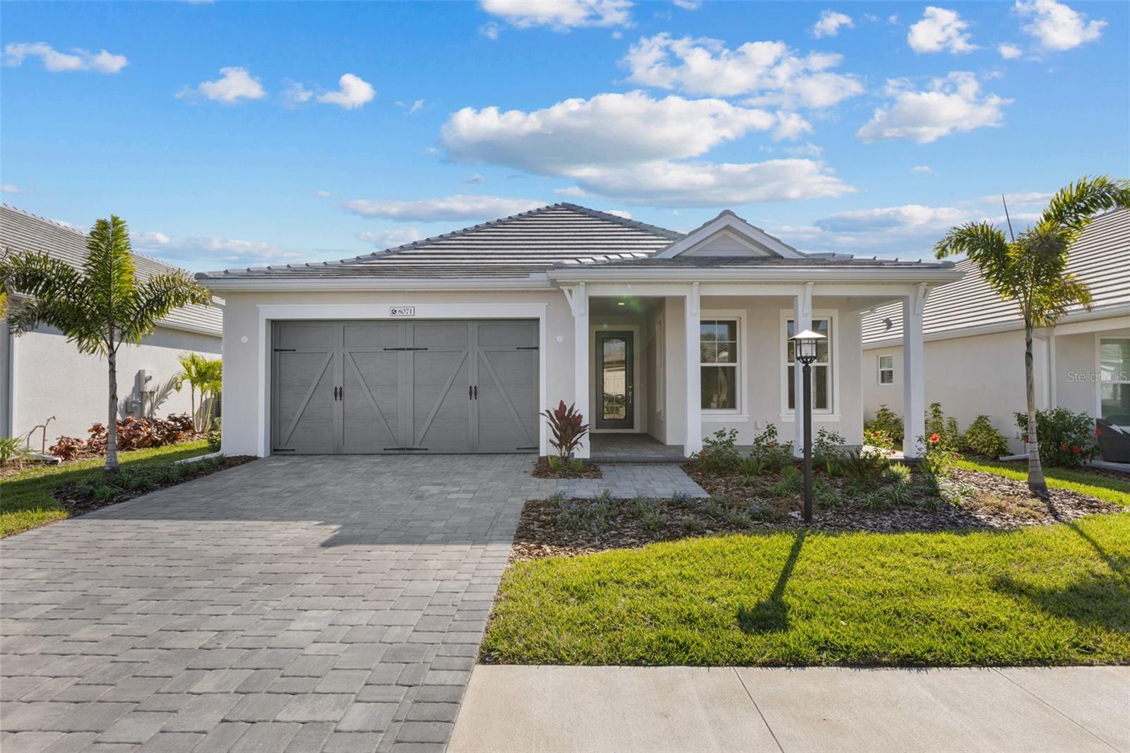 Exquisite Waterfront Living in Lakehouse Cove at Waterside
Welcome to 8071 Slipway Dr, a brand-new, never-lived-in home in the highly sought-after Lakehouse Cove at Waterside in Lakewood Ranch. This stunning 4-bedroom, 3-bathroom residence offers a seamless blend of modern elegance and coastal charm, perfect for those seeking a refined Florida lifestyle.
Step onto the inviting front porch before entering this beautifully designed home with tiled floors throughout the main living areas and upgraded carpeting in the bedrooms. Just off the foyer, two spacious bedrooms share a well-appointed bath with a walk-in shower, while a private guest suite on the opposite side features its own bath, walk-in shower, and ample closet space.
The heart of the home is an expansive open-concept kitchen and living area, bathed in natural light from four large glass doors and windows. The chef’s kitchen boasts sleek grey cabinetry, quartz countertops, gas cooking, and a spacious walk-in pantry—perfect for entertaining. The adjacent living space extends seamlessly to the lanai, where tranquil water views create a serene backdrop.
Retreat to the luxurious primary suite, featuring soaring ceilings, a spa-like ensuite with a large walk-in shower, dual vanities with quartz countertops, and an oversized walk-in closet. Additional highlights include a well-equipped laundry room with cabinetry and a sink, and thoughtfully designed storage throughout. Hurricane impact windows mean you wont have to worry about installing shutters, and gives you great peace of mind. Lawn Maintenance is included in HOA fees.
As a resident of Lakehouse Cove, you'll enjoy resort-style amenities, including a state-of-the-art fitness center, clubhouse, resort-style pool, pickleball, a playground, and scenic walking trails, and a water taxi stop that takes you to Waterside downtown area . Explore Waterside Place, just minutes away, where boutique shopping, fine dining, and cultural events create a vibrant waterfront destination.
Experience the best of Lakewood Ranch living in this extraordinary new home. Schedule your private showing today!