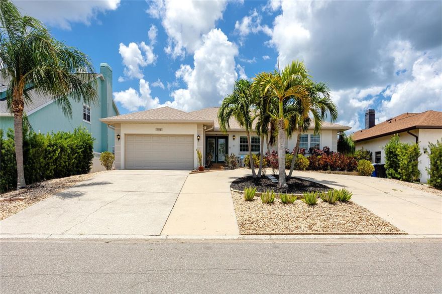 Apollo Beach living at its finest with this well-maintained 3-bedroom, 2-bathroom waterfront pool home. Step through the primary bedroom's French doors in the morning to the covered lanai with its warm wood-plank ceiling and freshly sealed paver deck for a cup of coffee and enjoy the tranquil canal views that frame the full back of the property.

Inside, the main living area flows into a custom bar with a wood soffit and new recessed lighting overhead that anchors the kitchen and living room as the social center of this open floor plan. The kitchen features wood-inlay countertops freshly sanded and resealed, a new refrigerator, and an adjacent dining room with a full bay of windows. Vaulted ceilings carry through the living space, and hardwood floors run consistently across the main areas.

The primary suite is nearly 20 feet across with two walk-in closets and a full en suite: dual vessel sinks on granite, a private water closet, and a glass-enclosed shower. The guest bath matches the attention to detail with full-height tile, a glass block window, and a copper vessel sink on granite. Both guest bedrooms are independently accessed and well-sized. Inside laundry and a two-car garage round out the practical side.

The backyard is designed for enjoyment. The covered lanai runs the width of the house under a tongue-and-groove wood ceiling with a coastal ceiling fan overhead, providing a shaded sitting area with water views fully visible through the screened pool enclosure. The paver deck has been sanded and sealed, the pool sits center in the enclosure, and the screened cage runs nearly 50 feet across the property line. Past the enclosure, a path through the palms leads down to the dock. Two Adirondack chairs face the canal at the water's edge. The lift is operational and ready, with both motors recently replaced, a new control panel installed, and the [3,000 lb?] lift fully serviced. Neighboring boats are visible in both directions. The canal connects out, and the Gulf and Intracoastal are both a short run from here.

Practical updates have been managed, offering peace of mind. The roof was replaced at the end of 2024, the AC and water heater are both under three years old, and all exterior plumbing above grade has been replaced. Every outlet and switch plate is new, and a whole-house generator is installed and wired to run the full home, air conditioning included, without interruption. New exterior floodlights offer an additional level of security, and the system is wired and ready to activate.

Then there's the elevation. This home sits measurably higher than its neighbors — visible from the street — and did not flood during the 2024 storm season.

Located in Apollo Beach with quick access to Tampa Bay, the TECO Manatee Viewing Center, Little Harbor at Ruskin, and the SouthShore corridor. Downtown Tampa and MacDill Air Force Base are both reachable in under 30 minutes via I-75, and Tampa International Airport is roughly 25 miles north.