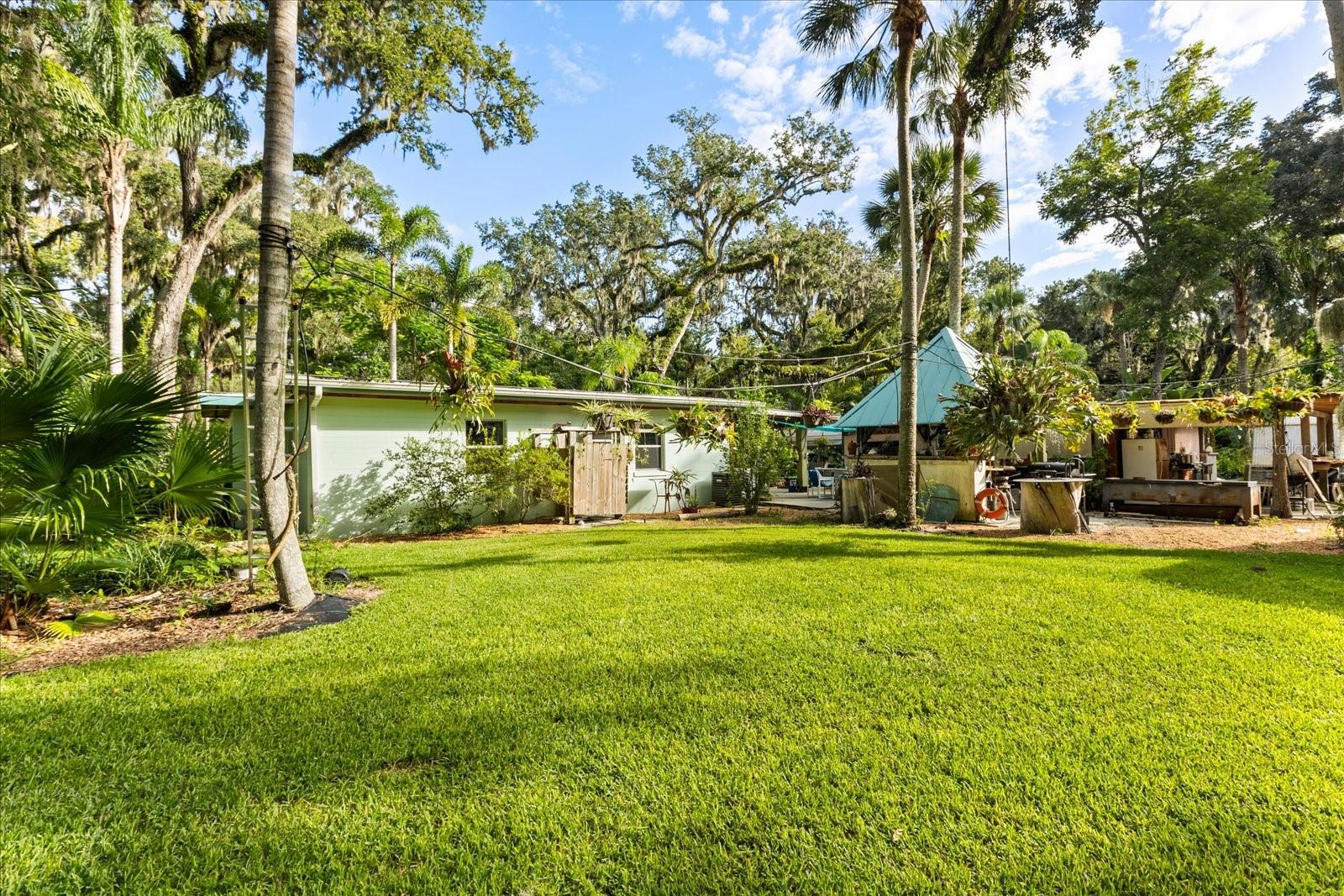 Charming Coastal Retreat
Welcome to your ideal getaway just two miles from Daytona beach! Nestled on a generous 3.6-acre lot, this delightful two-bedroom, one-bath home offers both space and serenity. The property is surrounded by lush greenery and a variety of fruit trees, creating a peaceful natural setting with the bonus of homegrown delights. Inside, you’ll find not only a comfortable living area but also a versatile den/office space, perfect for working from home or creating a cozy retreat.
In addition to the charming main residence, the property features extra space that can be converted into rental accommodations, making it a great opportunity for additional income. For those with a taste for adventure or guests traveling in RVs, there are three RV connections available on-site.
Altogether, this home is a perfect blend of coastal convenience, natural charm, and flexible living space. Come see it for yourself!
