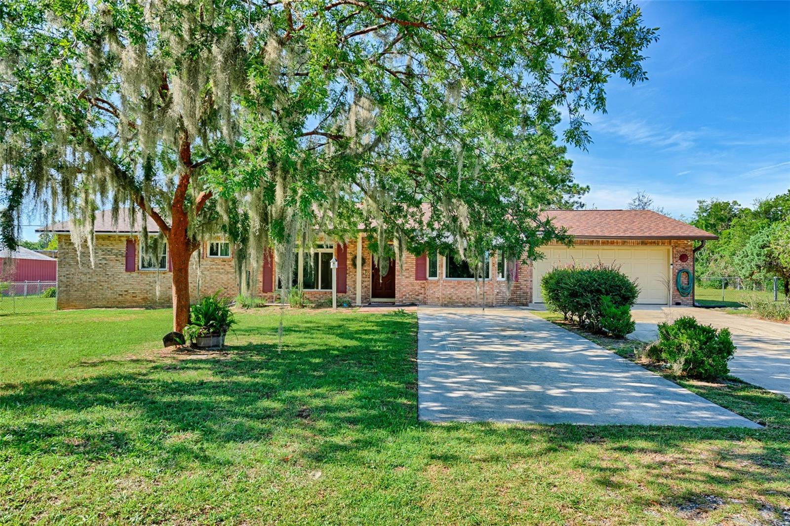 Well-maintained 2-bedroom, 2-bath brick home offers 1,831 sq ft on just over half an acre. The large living room welcomes you with a bay window filling the space with natural light. A spacious 24 x 14 family room/den with its own closet could easily serve as a third bedroom, with a bay window and glass French doors. The dining area flows into a Florida/sun room overlooking the large fenced backyard. The kitchen has Corian countertops, maple cabinetry, a breakfast bar, closet pantry and two ovens—one built-in plus the range. The primary and second bedrooms each have walk-in closets. Upgrades include newer windows throughout, new HVAC, new roof and updated plumbing relocated to the attic. The oversized two-car attached garage offers a workbench, cabinet storage, and access to the kitchen through the laundry area with storage cabinets and work sink. Enjoy a fenced backyard with storage shed. Conveniently located just outside Keystone Heights—near Mike Roess Gold Head Branch State Park, Keystone Beach & Geneva Jungle, Palatka–Lake Butler State Trail, Keystone Heights Airport, and Florida International Rally & Motorsport Park. Only 30 miles to Gainesville and 60 miles to Jacksonville.