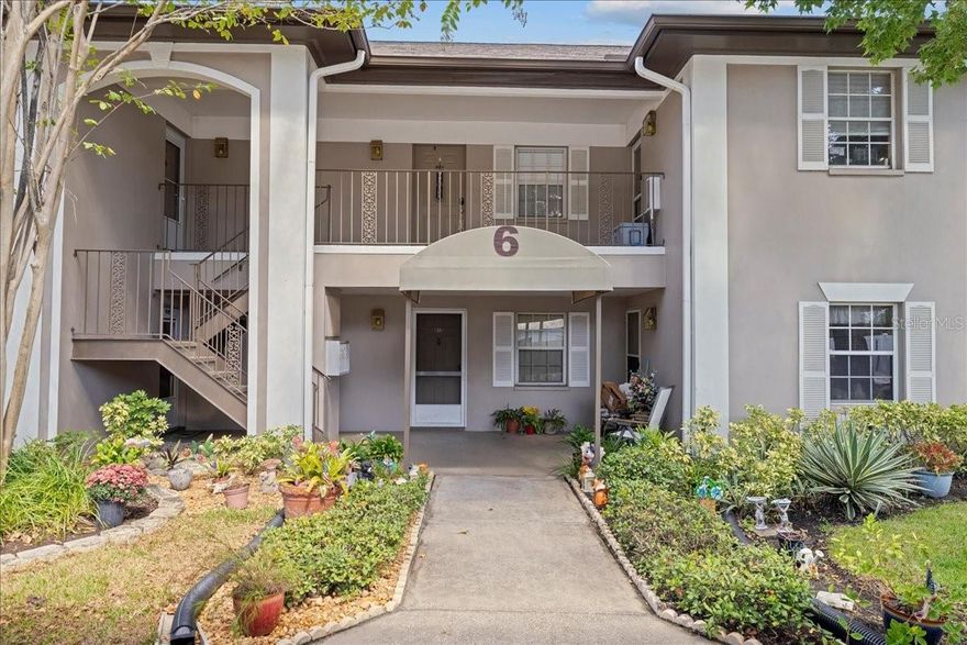 Welcome to this well-maintained 2nd floor condo in the desirable Bay Oaks community, offering comfort, functionality, and a bright, open layout designed for easy Florida living. The kitchen is light and spacious with plenty of cabinets and counter space, a cheerful tile backsplash, a pantry, and a convenient pass-through to the dining and living areas—perfect for entertaining or casual dining. The open concept living and dining area feels spacious and airy with vaulted ceilings, updated vinyl flooring that flows throughout, and large glass sliders that lead to a private screened balcony. Surrounded by mature trees and nature views, this outdoor balcony space creates a relaxing living area extension featuring stylish tile flooring, a ceiling fan, and a laundry closet with a full-size washer and dryer. The primary bedroom offers abundant natural light, private balcony access, room for a king-size bed and additional furnishings, a ceiling fan, and a mirrored walk-in closet for generous storage. Its private en-suite bath includes a spacious vanity, bright lighting, and a tiled walk-in shower. Located down the hallway with the guest bath and two hall closets, the second bedroom is a nice-sized room that features a large window and a wall closet, making it ideal for guests, a home office, or a bonus room. The guest bath offers a clean, classic tile surround, an oversized vanity, and a large mirror with bright lighting for a polished finish. Bay Oaks provides a quiet, welcoming atmosphere with mature landscaping, a pond with a fountain, a community pool with some shaded seating, and a convenient grilling area. Covered parking and guest spaces are close to each building. Centrally located with proximity to grocery stores, restaurants, gyms, shops, and near airports and main thoroughfares for easy commutes. Less than 10 miles from Clearwater’s world-famous beaches. "This home comes with a 13 MONTH HOME WARRANTY for buyer's Peace of Mind and to help make transitioning easier!" Don’t miss your opportunity -Schedule your private tour today!