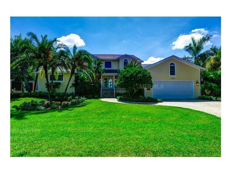 HARBOR ACRES WATERFRONT!  Tucked away in a protected waterway off of Sarasota Bay is this gracious two-story residence.  A double door entrance presents the foyer, a formal dining room and a main living area with a wood-burning fireplace.  The home features rich hardwood flooring, quarry stone tile, soaring custom and vaulted ceilings, crown moldings, designer fixtures, recessed and accent lighting, handcrafted built-ins and Palladian windows as well new as Hardie board siding, hurricane rated windows and doors.  The expansive kitchen offers a center-island and a breakfast bar, sleek European-style cabinetry in neutral white, dual ovens, a stainless steel refrigerator and a gas cook-top.  Adjacent is a morning room and a combination family room with a built-in media center.  Upstairs, the master suite overlooks a private balcony with bay views and has a personal bath with dual sinks, a jetted soaking tub and a separate shower.  The loft flows seamlessly into a second floor bedroom.  An office/study, a guest bedroom with a private screened lanai, a third bedroom, a laundry room, two full bathrooms and a powder room complete the lower level.  Multiple sets of French and sliding doors access the many outdoor recreation areas; a screened and covered lanai, an extended deck that frames the rear of the home plus an open-air pool and spa overlooking the bay.  The coveted deep sailboat waters naturally appeal to all water enthusiasts with 2 docks and 2 lifts!  Located just South of Downtown Sarasota!