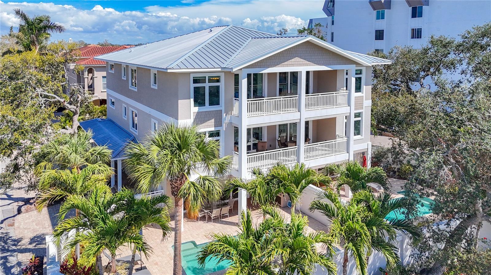 Welcome to an unparalleled luxury coastal retreat in the heart of SIESTA KEY, home to Tripadvisor’s #1 Beach in America! This turn-key luxury vacation rental boasts a potential $966,192 in first-year cash flow ($575,000+ from rental income and up to $391,192 from 100 percent bonus depreciation, reinstated by the Big Beautiful Bill), making it an extraordinary investment opportunity. Built in 2017 to the highest standards, this exquisite three-story estate offers 10 bedrooms, 8 full bathrooms, 2 half baths, 2 private heated pools, 2 outdoor kitchens, and a 4-car garage. Just steps from the world-renowned Siesta Key Beach via private deeded beach access, this property is a true diamond among Siesta Key’s aging real estate market. With no rental restrictions, no HOA fees, a proven rental track record, excellent guest reviews, and steadily increasing occupancy and nightly rate performance, it’s priced below Zillow Zestimate with motivated sellers.
The concrete block structure ensures durability, while the meticulously crafted interior features high-end finishes, including soaring ceilings, tile flooring, and gourmet kitchens with Jenn-Air appliances, granite countertops, solid wood cabinets, and expansive islands. Each master suite includes a spa-like en-suite bathroom with a soaking tub and stand-up shower. With 2 private entrances, 2 private elevators, and 2 private garages, this fully furnished estate is designed for guest convenience and low maintenance.
Perfect for investors seeking a high-performing asset in a prime location, this Siesta Key masterpiece combines modern amenities with the allure of America’s top-rated beach. Don’t miss this rare opportunity to own a luxury vacation rental with a stellar rental
history in one of the most coveted coastal destinations!