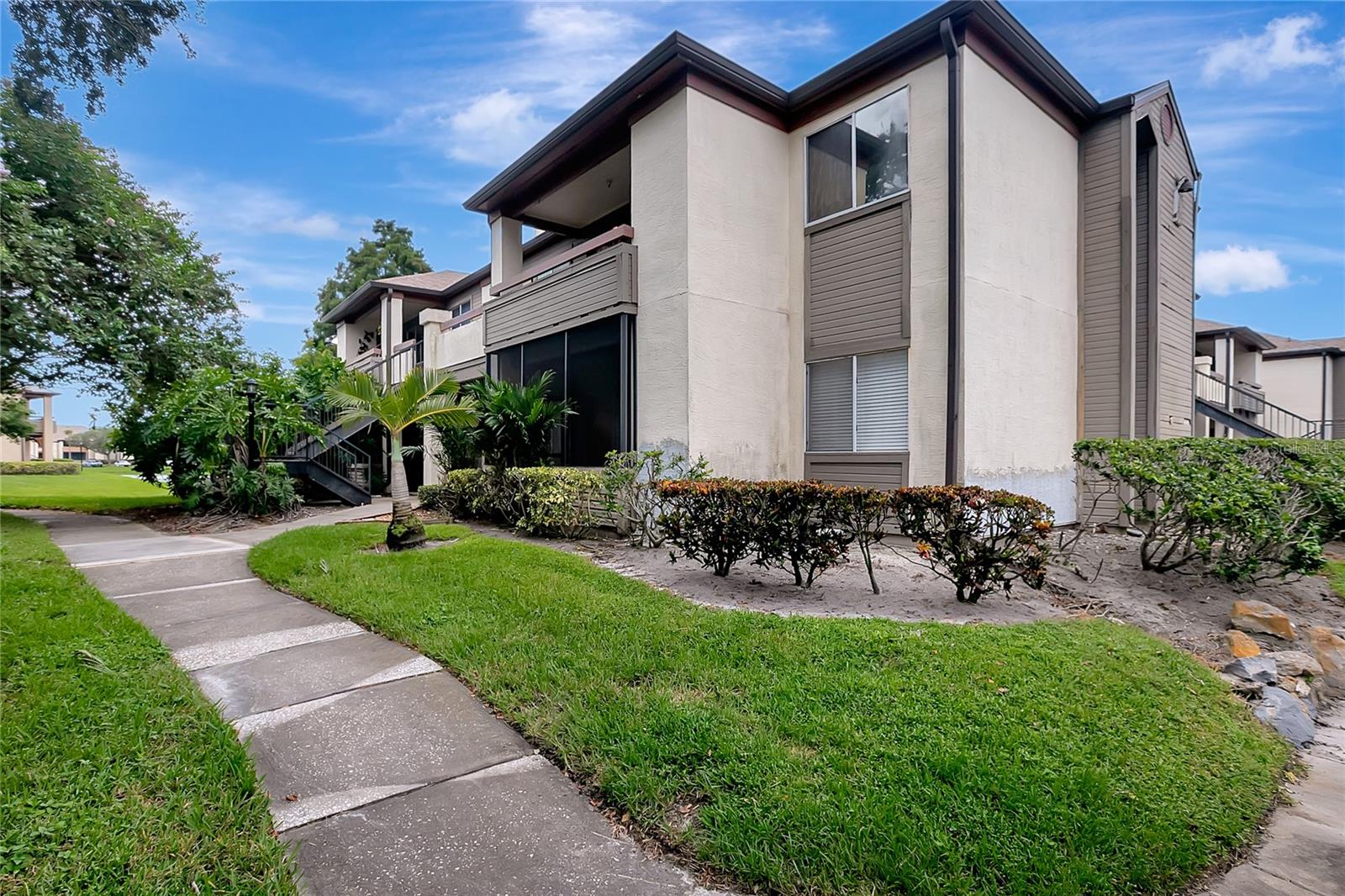 Move-in ready 2BR/2BA condo in gated Itopia Private Residences! This second-floor corner unit features a split-bedroom layout with two en-suite bathrooms and walk-in closets—perfect for privacy or guests. Enjoy vaulted ceilings, a fireplace, granite counters, stainless steel appliances, and in-unit laundry. Community amenities include 2 pools, hot tubs, tennis & racquetball courts, fitness center, clubhouse, and more. HOA includes cable, internet, trash, and security. Prime location with easy access to I-275, Gandy Bridge, downtown St. Pete, and Tampa. Pet-friendly community!