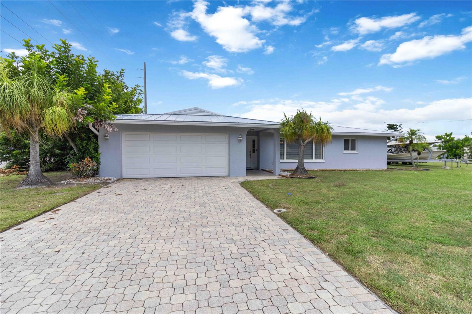 A BOATER'S DREAM in Rock Creek! This rare DOUBLE-MASTER, WATERFRONT POOL home sits on a private oversized CORNER LOT with Gulf access, a BRAND-NEW 6,000-lb BOAT LIFT, fish prep station, and over 140 feet of concrete seawall. Offered FULLY FURNISHED and TURN-KEY, it’s packed with updates and offers sparkling water views from nearly every room—truly a home with the WOW factor!
Recent upgrades include a BRAND NEW METAL ROOF, fresh INTERIOR and EXTERIOR PAINT, and the new boat lift for easy Gulf access. Inside, you’ll love the PAVER DRIVEWAY, GRANITE countertops with a patio pass-through, granite island breakfast bar, smudge-proof stainless steel appliances, and tile throughout the kitchen, living, and Florida room. Additional features: double padding under the carpet, an enclosed glass shower with custom floor-to-ceiling tile, dual vanities with granite tops, crown molding, and a newer heated pool with heat pump (approx. 3 years old).
Relax in the massive air-conditioned Florida room (34x10) and watch the sunset over the water, or take a private late-night dip in your heated pool. By land, you’re only two miles to Englewood Beach via golf cart, and less than a half-mile to Publix, Winn-Dixie, CVS, and Englewood Community Hospital. By water, cruise with dolphins to Farlow’s on the Water, explore the Lemon Bay Aquatic Preserve, or head just 4 miles to Stump Pass for direct Gulf access.
This is Florida living at its best—turn the key, drop anchor, and start your new coastal lifestyle today!