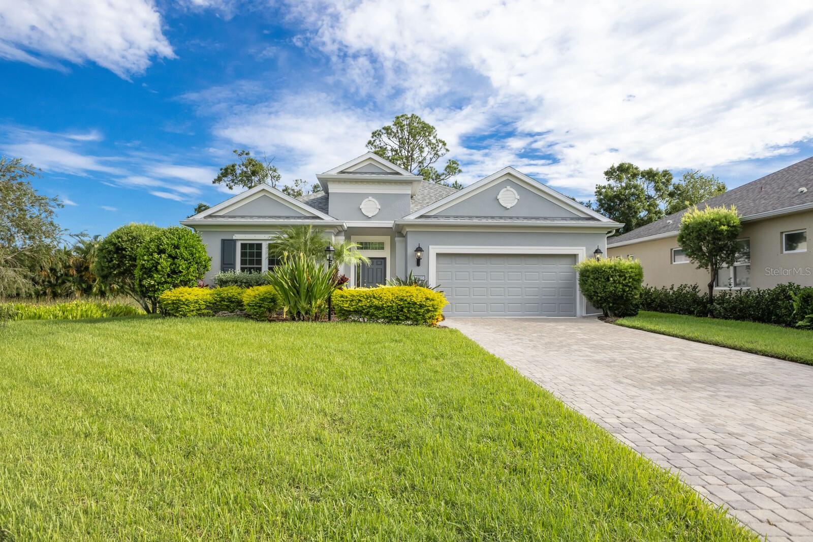 You will not want to miss this lovely home. Surrounded on 3 sides by green space and nature preserve, this popular Neal Homes Eventide floor plan has been beautifully upgraded and meticulously maintained. Starting with the front entrance, you’ll find an exceptionally long paver drive, as the home is set back for extra privacy and curb appeal. Step inside to a wide-open floor plan showcasing living, dining, and kitchen spaces. Floors are 7” wide plank-style porcelain tile throughout. The Great Room and Primary bedroom have coffer ceilings, which add 2 ft height to the already 10 ft ceiling height. The kitchen features under-cabinet lighting, an abundance of pot drawers, contemporary fixtures, granite counters, and a full-height eat-at island. The chef in the family will love the gas cook stove. A large bank of pocket sliding glass doors, plus 2 large windows, lead to the extended lanai and bring the green outdoor space in to enhance the living space. The front door has a retractable screen door, so you can open both sliders and front door to enjoy a cross breeze. The primary suite is a delight, with a large walk-in closet, additional storage closet in the bath, dual sinks, and a large walk-in shower. 2 guest suites share a bath and are separate and private from the primary bedroom. The lanai has been extended and offers an exceptionally peaceful space to enjoy the Florida wildlife and greenery. The home has been recently enhanced with new impact windows and doors throughout, a solar attic fan, and exterior is freshly painted. Woodland Trace is a gated community of only 45 homes, nestled amidst wetlands, lakes, and nature preserves, yet close to it all. This home enjoys the ultimate privacy, as it sits near the end of one of three cul-de-sacs in the neighborhood, adjacent to a pond, across the street from one of the preserves, with another preserve in the backyard. There is room for a small pool, and the Seller has a conceptual design and estimate available. Landscape care and irrigation are included in the low HOA dues, and there is no CDD fee. Centrally located along the popular University Parkway corridor, between Sarasota and Lakewood Ranch, Woodland Trace is just minutes to Palm Aire and University Park Country Clubs, and provides easy access to beaches, top-rated schools, cultural activities, shopping, and dining. Homes rarely become available in this sought-after Community so call today to schedule your private showing.