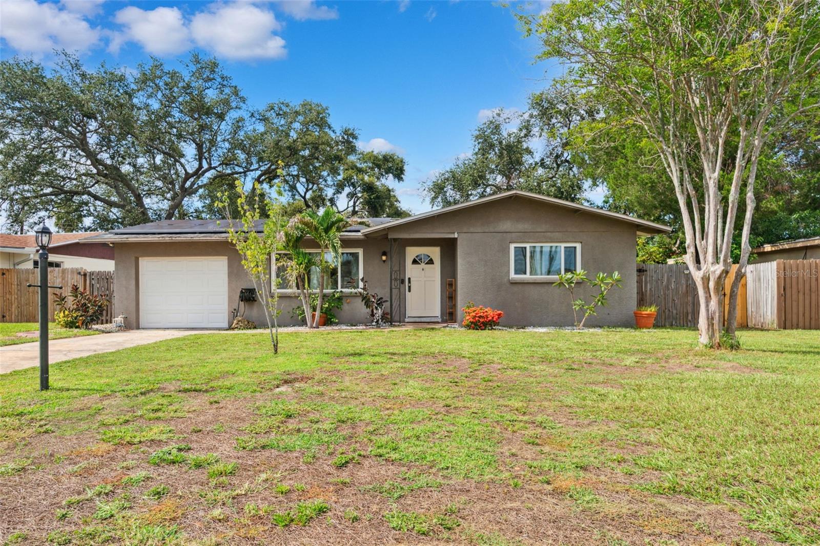 Welcome to 11115 101st Ave, a well-maintained 2-bedroom, 2-bathroom home located near the end of a quiet street just steps from a cul-de-sac. The homes numerous windows fill the living spaces with abundant natural light. This home has received multiple valuable updates. Recent improvements include a shingle roof (2017), HVAC system (2019), whole-house re-piping (2015), and an updated electrical panel (2015). The home comes with owned solar panels for energy savings, as well as a whole-home water softener system. The AC, electrical, and plumbing systems were all recently serviced and given a clean bill of health. Situated on a spacious lot with plenty of room to add a pool or create a garden. Down the street from Walsingham park and 5 miles to the beach, this property offers comfort, efficiency, and space to grow. All just minutes from shopping, dining, and commuter routes.