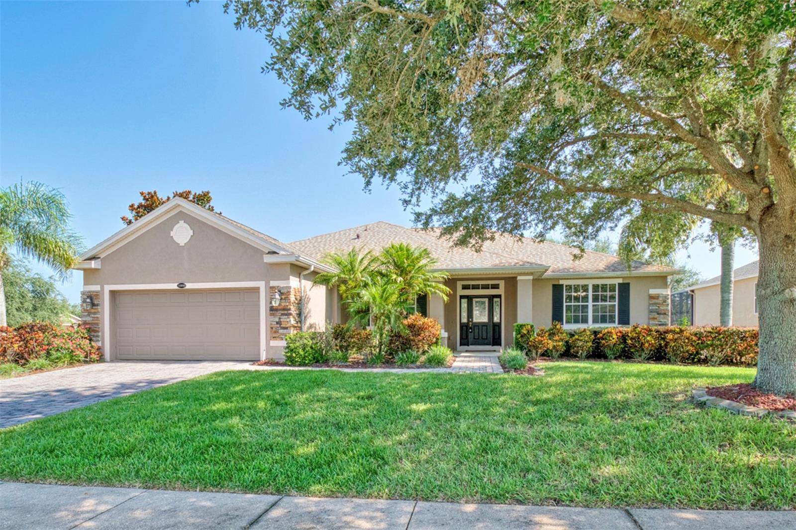 Don't miss this incredible opportunity to own a spacious, move-in-ready pool home in one of Clermont’s most desirable neighborhoods—Legends, a guard-gated golf course community offering security and beauty, in a great location. Whether you’re hosting guests, accommodating extended family, or simply looking for room to grow, this property genuinely checks all the boxes. Sitting pretty on a large corner lot, imagine pulling up to a welcoming paver driveway, surrounded by fresh landscaping, and knowing your home is topped with a brand-new roof (2024). Step inside and feel the brightness. The interior, freshly painted in 2025, is bathed in natural light, with cathedral ceilings and a lovely mix of hardwood, ceramic tile, and luxury vinyl plank flooring underfoot. An impressive central staircase draws your eye, flanked by a formal dining room, a private office for quiet moments, and a spacious living room perfect for your next gathering. The kitchen is thoughtfully designed with granite countertops, 42” cabinets, and a suite of stainless steel appliances, including a gas stove and a handy warming drawer. Plus, there’s a walk-in pantry for all your culinary treasures. Right off the kitchen, a cozy breakfast nook leads out to a two-story screened balcony overlooking the sparkling pool — perfect for your morning coffee or unwinding as the sun sets. The primary suite easily accommodates a king-sized bed with plenty of room to spare. You'll love the convenience of dual closets and the fresh feel of the new flooring (2025). The en suite bath is big and perfect with a soaking tub, a separate shower, dual vanities, a linen closet, and a private water closet. Two more bedrooms on the main floor, also featuring new flooring, share a spacious full bathroom. What truly sets this home apart is the fantastic bonus downstairs: a second full living area! This versatile space includes two additional bedrooms, a full bath, a second kitchen area (without a range), and a huge recreation/family room. With equal square footage upstairs and down, it’s an absolute game-changer, whether you have kids and teens who need their own zone or you're looking for the ideal setup for multi-generational living. Outside, your backyard is a private paradise, fully enclosed in a two-story screen so you can enjoy bug-free Florida living. Picture yourself lounging by the PebbleTec-finished pool, firing up the grill, sitting under the pergola, or gathering around the fire pit for evening stories. You'll also appreciate the significant recent upgrades that offer true peace of mind: Water heater (2021), Pool pump (2024), Sump pump (2025), HVAC (Upstairs 2022 Downstairs 2025), Roof (2024), Interior paint & flooring (2025). Ready to see it for yourself? Schedule your private showing today!