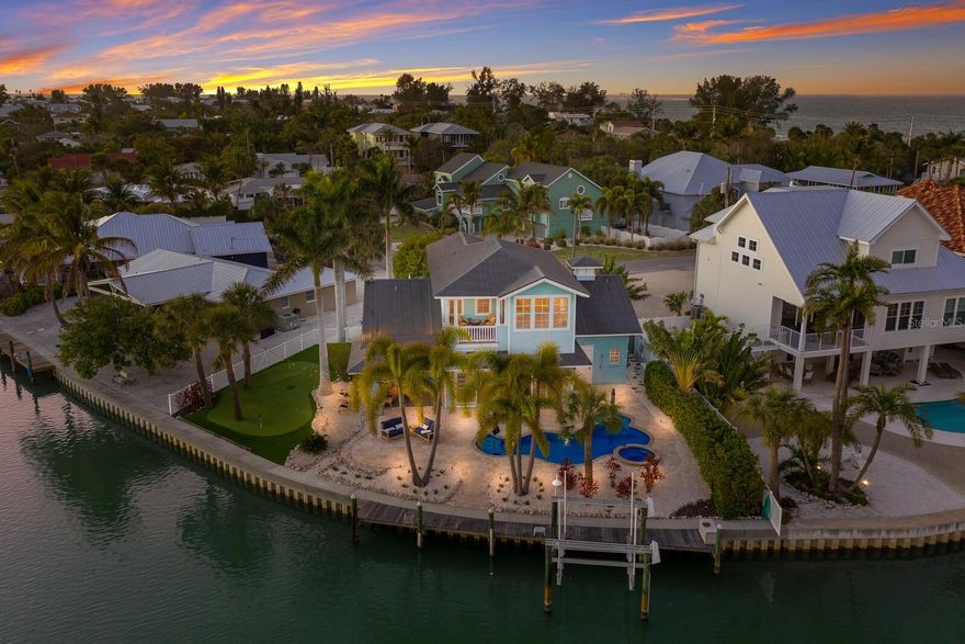 Florida sunbathing, boating, kayaking, fishing and crabbing are all in your future! Welcome to this stunning 3-bedroom/2.5-bath Anna Maria Island home with approximately 117 feet of waterfront (approximately 0.25 acre). Relax on the expansive patio deck and watch dolphin and manatee swim by, or enjoy the abundance of Green Parakeets, Egrets, Pelicans, Osprey, Herons, and even the local bald eagle that this picturesque location offers. This 2,754-square-foot open-concept residence has great space for entertaining and large family gatherings. The kitchen includes granite countertops, a large number of custom cabinets and plenty of countertop seating for 8-10 guests. This island retreat features a large second-floor primary en-suite with walk-in closet, sitting/reading area and sliding doors out to a balcony with full water views. The first floor offers two additional bedrooms, one with a door that leads to a large waterfront entertaining area and private putting green. For boaters, there is water access to the Intracostal Waterway, Tampa Bay, and the Gulf of Mexico. For golfers, no need to drive to the mainland to get in a round – besides owning your private putting green there is a private golf club, only minutes away. Also, no homeowners association, fees or rules. Just a short golf cart ride away are Anna Maria Island’s famous beaches and a variety of fabulous dining and shopping opportunities. Enjoy sunsets and sunrises from your very own island home. Weekly rentals are permitted however the current owners do not rent this property. Please ask your agent for the interactive 3D walk-through and drone video link. This is island living at its finest – Don’t let this one get away!