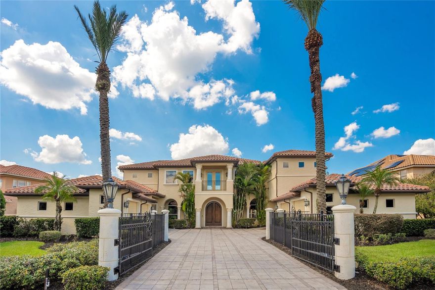Discover this luxurious Mediterranean Style Home with this stunning 4-bedroom, 5-bathroom estate, a 6,978 sq. ft. masterpiece nestled on nearly half an acre in the prestigious Reserve at Belmere, Windermere. With breathtaking views of Lake Whitney, this property offers elegance and sophistication at every turn. As you approach, you’ll be captivated by the grand curb appeal, featuring mature landscaping, a private gated entrance, and a custom-tiled driveway leading to four spacious garages, perfect for parking or extra storage. Step through the striking double arched wooden doors, and you'll feel transported into a majestic castle, featuring a beautiful custom vintage European accent painting on the wall leading to the second floor, a grand curved staircase, and rich wood flooring. The expansive living room showcases panoramic views through 4-panel glass doors that open to a serene pool and lakefront oasis. Adjacent is the dining area, where the wooden accent ceiling and statement chandelier set the perfect tone for hosting. The gourmet kitchen is a chef’s dream, with dark, elegant cabinetry, marble countertops, custom-tiled backsplash, stainless steel appliances, and an island designed for entertaining. An additional living space adjacent to the kitchen, surrounded by windows and sliding doors, bathes the room in natural light and opens to the backyard, perfect for seamless indoor-outdoor living. Upstairs, a loft area invites you to unwind, while the master suite is a sanctuary of opulence with its antique-inspired decor, bespoke wall art, and lavish ensuite bathroom featuring dual vanities, a chandelier-lit garden tub, and a walk-in tiled shower. The remaining bedrooms match the home's elegance, offering ample natural light and sophisticated design. This home also boasts a private movie theater, outfitted with luxurious seating, theater flooring, and towering columns to elevate your viewing experience. Outside, the lavish backyard is an entertainer's paradise. An outdoor kitchen with a fridge, grill, sink, and fireplace overlooks the massive pool and spa, with scenic views of Lake Whitney beyond. A private boat dock, complete with a shaded lift, offers direct access to the lake, perfect for boating, jet skiing, or fishing. This is more than just a home—it’s a lifestyle. Experience this home firsthand and discover a new level of luxury living.
<div style="padding:56.25% 0 0 0;position:relative;"><iframe src="https://my.matterport.com/show/?m=akhwJjxrj3j&mls=1" frameborder="0" allow="autoplay; fullscreen" allowfullscreen style="position:absolute;top:0;left:0;width:100%;height:100%;"></iframe></div>