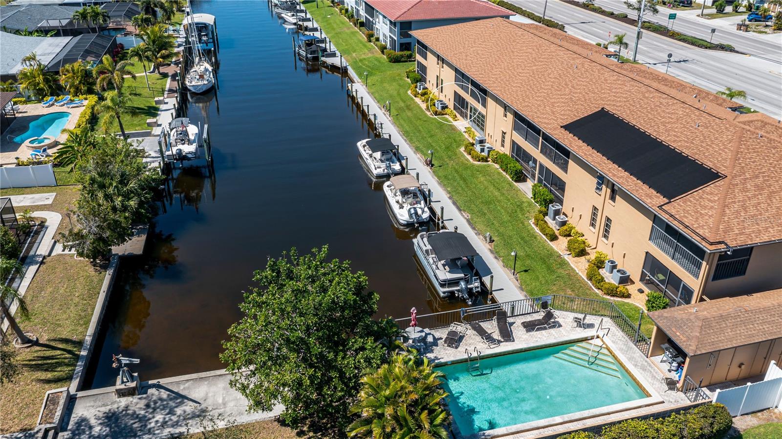 Discover true paradise with this First Floor, Sailboat Gulf access, Waterfront condo! No history of flooding here!!! This unit features hurricane impact windows for added peace of mind. The kitchen has been updated with granite countertops, soft close cabinets, and modern finishes. The seller is offering a credit of $5,000 towards new flooring so you can update it with your own personal taste! A newer AC (2020) and new water heater have been installed. Enjoy peaceful waterfront views from the comfort of your own lanai or enjoy it while relaxing by the community pool in this 55+ community. Take advantage of the pier and dock for fishing, boating, or kayaking. Boat dock slips are available on a first come, first serve basis. This condo also includes an assigned, covered parking spot right outside your door and a separate storage unit for your convenience. Located in the heart of Cape Coral, just minutes away from an array of restaurants, shopping, and entertainment options. Experience Florida living today!