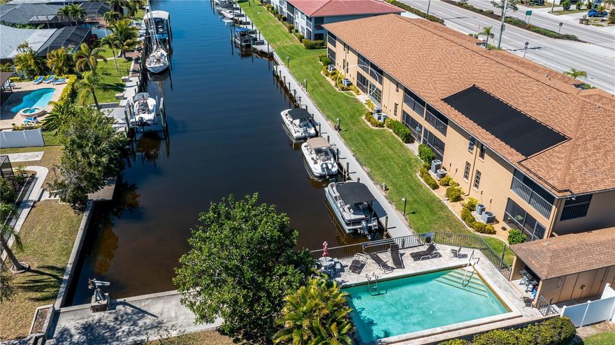 Discover true paradise with this First Floor, Sailboat Gulf access, Waterfront condo! No history of flooding here!!! This unit features hurricane impact windows for added peace of mind. The kitchen has been updated with granite countertops, soft close cabinets, and modern finishes. The seller is offering a credit of $5,000 towards new flooring so you can update it with your own personal taste! A newer AC (2020) and new water heater have been installed. Enjoy peaceful waterfront views from the comfort of your own lanai or enjoy it while relaxing by the community pool in this 55+ community. Take advantage of the pier and dock for fishing, boating, or kayaking. Boat dock slips are available on a first come, first serve basis. This condo also includes an assigned, covered parking spot right outside your door and a separate storage unit for your convenience. Located in the heart of Cape Coral, just minutes away from an array of restaurants, shopping, and entertainment options. Experience Florida living today!