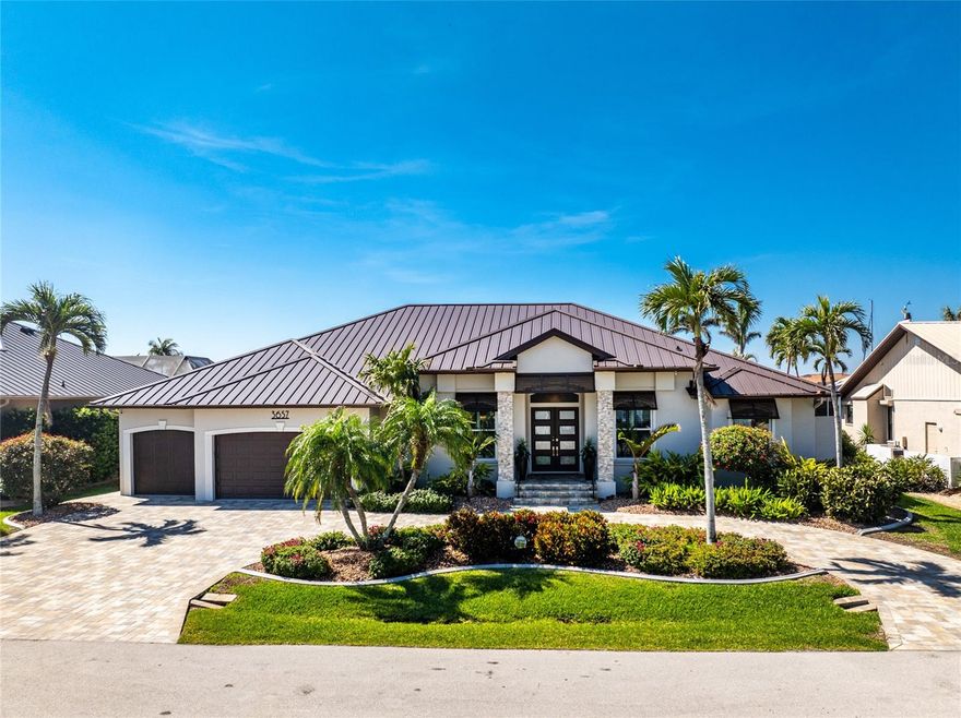 You will absolutely LOVE this spectacular canal front 4-5 BR home on an oversized 100 x 120 ft lot in charming Punta Gorda Isles! As you approach this stunning home on it’s circular paver driveway, you will be impressed by the smart, up to date look with stack stone columns, modern double entry doors and Bahama style shade awnings. Behind the 2 garage doors, one doubled one single, is a roomy, epoxy floored, mini split cooled, garage, room for 4 cars on the floor and adequate height for a car lift, ideal for the car enthusiast. There is also a separate 60+ SF storage room with central air.As you enter your stunning new home through the keyless entry, double front doors the view will take your breath away. The great room with double tray ceiling, with romantic mood lighting, and built in shelving with hidden speakers is SO inviting with its mantle topped gas fireplace on a stack stone wall, But that’s not all! The lofty 12’ ceilings and 21 ft of “disappearing” hurricane rated sliders configured in a “zero corner” fashion that lead to the lanai and pool make your indoor and outdoor entertaining flow uninterrupted. The outdoor living is at it’s best with the 32’ x 15’ covered area, travertine pool deck, fully equipped outdoor kitchen, attractively shaped and lit 30’ x 15’ sparkling pool with a water feature and attached spa with spillover. The whole outdoor 46’ x 25’ area with panoramic, no see um screen is huge. A natural spray system also keeps bugs away. Look further to the 100’ of canal waterfront seawall and 85’ of dock. You have room for a really big boat at the dock, PLUS a 18,000 lb lift for a sizable day boat, PLUS a jet ski lift! You have room for it ALL! It’s only 8-10 (no wake) minutes to get out to the Ponce de Leon inlet and to the open sparkling water of Charlotte Harbor, then onward to the Intracoastal waterway and Boca Grande Pass then out to the Gulf for some spectacular deep sea fishing. After your day out on the Gulf and back in your new home, take a nap in your 18’ x 16’ owner’s suite with it’s plantation shuttered, hurricane slider access to the pool. There is a room near the entrance of the BR that the present owner has made into a humongous “closet” that would also be suitable as an office or smaller BR. There’s even HW floors and a smaller closet within this ”closet”!On the other side of the house is a well thought out wing with a guest bath with a Roman shower and 2 more bedrooms, one having slider access to the pool, the other with access to a private outdoor, under roof courtyard in addition to a large office, totally outfitted with built ins and en suite bathroom. The office also has access to the courtyard with it’s outside entrance, so guests coming to the office do not need to come through the house. There's an auto on whole house generator & buried 500 gal. propane tank. "Punta Gorgeous" is loaded with charm,lots of great restaurants,a historic district and tons of waterfront parks. With walking and biking trails, a dog park, the popular Fishermans Village  (shops with even more restaurants),Isles Yacht Club, and St. Andrew’s South Golf Club. There's a Farmer’s Market on Saturdays and a smaller one at the History Park and Artisan Village (next to the new library)on Sundays. Play Pickleball at the“Pickleplex”. If you are bored here, it's by choice. If you have found our delightful town of “Punta Gorgeous” then you are very, very lucky indeed! Now you just need this stunning home to make it your own paradise!