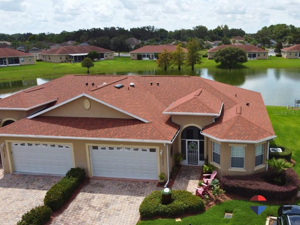 Step into this beautifully appointed, fully furnished home in the desirable 55+ gated community of Lakeside Landings — where amenities are abundant and neighbors are as warm as the Florida sunshine. This residence offers a split floor plan with a private primary suite and a separate guest wing, complete with its own full bath. A versatile den provides the perfect space for a home office, hobby room, or extra guest accommodations.
The oversized kitchen has been upgraded with stunning new countertops, ideal for both entertaining and casual meals. A brand-new roof (2025)offers peace of mind, while soaring ceilings create a light and airy feel throughout the home.
From the moment you step through the new leaded full-glass double doors, you’ll be captivated by the open sightline to the serene water view — with no rear neighbors. The fully screened lanai provides a tranquil, bug-free spot to relax and take in the scenery.
A brick paver driveway and extra private parking enhance curb appeal, while the community offers an incredible lifestyle. Residents enjoy a resort-style waterfall pool and hot tub, pickleball and tennis courts, a putting green, fitness center, ballroom, library, community kitchen, dog park, playground for grandkids, and more.
Located just minutes from shopping, dining, the new Costco in The Villages, and endless entertainment options, this home combines comfort, style, and location in one exceptional package. Don’t miss your opportunity to experience the Lakeside Landings lifestyle.