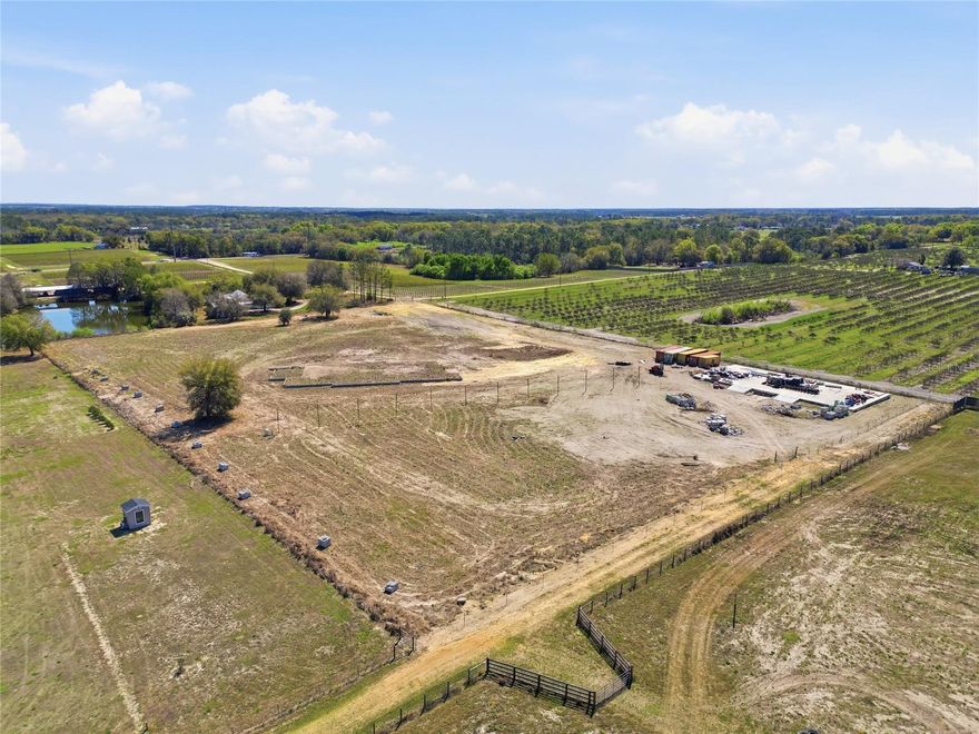 Rare, build-ready, nearly 7-acre property featuring an 8,000 sq ft concrete slab ready for warehouse building. Approved plans for a 4,500 sq ft custom home plus 4,500sf wrap around porch.  Impact fees paid.  A private 150 foot deep well installed,  saving significant time and upfront cost. Zoned agricultural with no HOA, the property offers flexibility for horses, workshops, or a private estate. Conveniently located near Clermont and within easy reach of Orlando, this unique homesite combines privacy, acreage, and convenience—a rare opportunity for buyers looking to build in the growing Groveland area. Seller financing available for up to $150,000 for qualified buyers.
