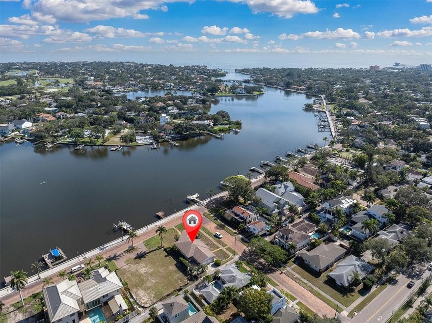An exceptional waterfront corner-lot opportunity offering both privacy and presence. This prime parcel includes a Coffee Pot Bayou water lot with a private dock across the street, creating the perfect foundation for a bespoke coastal estate. A rare chance to design and build in a premier setting where water views and lifestyle take center stage. Being sold as-is, home flooded with Hurricane Helene and was not remediated.