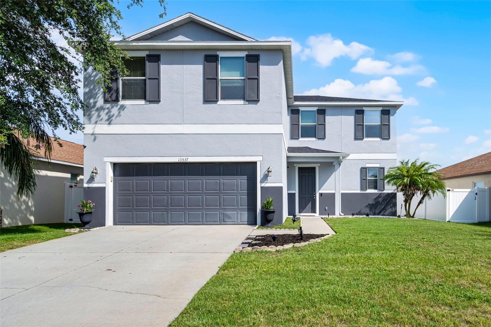 This stunning property in Clermont is waiting to be your new forever home! New roof in 2020 and new AC in 2025! This beautifully maintained 3-bedroom, 2.5-bathroom home with 2,529 sq. ft. of spacious living area has everything you're looking for to ensure the entire family falls in love. From the moment you arrive, the manicured front lawn and oversized driveway set the tone for what awaits inside: bright, open living and modern comfort. Step through the front door and into an airy, open-concept layout where the living room, dining room, and kitchen flow seamlessly together, perfect for entertaining or spending time with loved ones. The chef-inspired kitchen is equipped with stainless steel appliances, modern finishes, ample counter space, a large breakfast bar, and a cozy breakfast nook ideal for busy mornings or casual meals. A half bathroom on the main level ensures convenience and privacy when hosting guests. Upstairs, you'll find a spacious bonus loft, perfect as a TV room, play area, home gym, or whatever suits your lifestyle. All three bedrooms are upstairs, offering privacy, space and plenty of storage so everyone feels right at home. The two secondary bedrooms are generously sized, with ample closet space and natural light. From one of the front upstairs windows, you can even catch a glimpse of Disney's nightly fireworks, adding a touch of magic for your everyday routine. The primary suite is a true retreat, featuring a large walk-in closet and a luxurious en suite bathroom. The primary bathroom is complete with dual sinks for added convenience, a spacious walk-in shower and a large soaking tub, creating the ideal space to relax at the end of the day. Step outside into your own private outdoor oasis with the fully fenced-in backyard featuring a mix of lush grass and low-maintenance turf, and a covered patio area perfect for enjoying Florida’s sunshine year-round, whether you’re sipping your morning coffee or grilling on the weekend. Situated in a prime Central Florida location, you're close to Costco, additional great shopping and dining options, and minutes from top-rated schools. Additionally, you're only 25 minutes from Disney World and minutes away from the Florida Turnpike, putting all the fun of Central Florida right at your fingertips! Don’t miss the opportunity to make this incredible home yours, schedule your private showing TODAY!!!