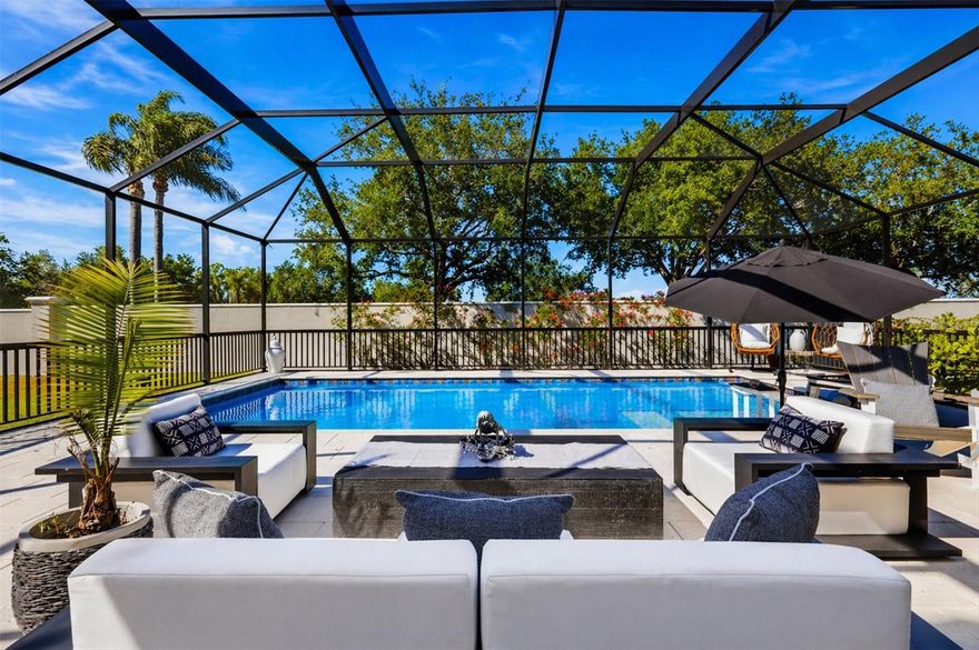 Welcome to your slice of Florida luxury in the highly sought-after gated community of Legends Bay, just minutes from the world-renowned IMG Academy. This beautifully updated 4-bedroom, 3-bath home offers the perfect blend of comfort, style, and functionality in a maintenance-free setting. Step inside to discover a light-filled, open-concept layout featuring fresh interior paint, new carpet, updated trim, and designer lighting throughout. The spacious kitchen is a true centerpiece, showcasing new quartz countertops, a stylish tile backsplash, Frigidaire appliances, a gas range, and a convenient pass-through pantry that connects to a large walk-in pantry—perfect for everyday living and entertaining. The thoughtfully designed floor plan includes a flex space just off the primary suite, ideal for a home office, gym, or private retreat. The primary suite also offers a unique and practical flow, with direct access to the laundry room through the oversized walk-in closet. Step outside to your private backyard oasis, complete with a brand-new pool, expansive pool deck, and a fully screened lanai enclosure. Enjoy outdoor living at its finest with a complete kitchen featuring a built-in gas grill, beverage refrigerator, and bar seating—perfect for hosting or relaxing under the Florida sun. Residents of Legends Bay enjoy access to a heated community pool, clubhouse, and a guarded gate for added security and peace of mind. This move-in ready home offers the ideal combination of luxury upgrades, smart design, and an unbeatable location. Schedule your private showing today and experience the lifestyle you’ve been waiting for.