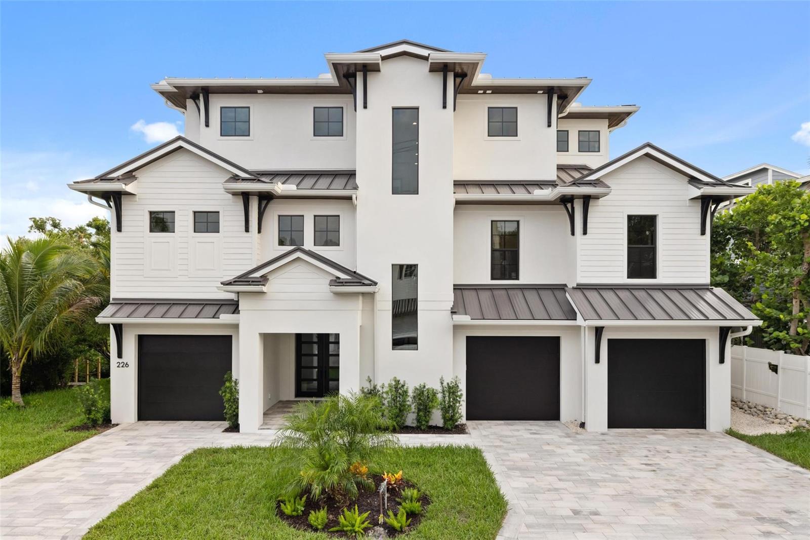 Introducing a stunning, move-in ready 2025 waterfront masterpiece tucked along a tranquil canal on a quiet street in the heart of Siesta Key - just minutes from the lively Village and the world-famous white-sand beaches that are consistently ranked among the very best.Designed for the ultimate coastal lifestyle, this elevated luxury residence blends modern craftsmanship with timeless elegance, offering both a serene retreat and an entertainer’s dream, all while providing unparalleled privacy and direct waterfront access. Spanning 4,009 square feet of impeccably designed air-conditioned living space, plus more than 2,000 additional square feet of versatile non-conforming area, this home is perfectly suited for every chapter of your life. With five spacious bedrooms, four full baths, two half baths, and a flexible bonus room, there is room for extended family, guests, or a home office. The rare six-car garage ensures plenty of storage for vehicles, golf carts, or recreational gear, while the additional non-conforming space can easily transform into a golf simulator lounge, private gym, wine cellar, or a state-of-the-art home theater - your imagination is the only limit. Outside, the property feels like your own private resort. Step into lushly landscaped surroundings designed for beauty and privacy, where the sound of palms swaying and water gently lapping the canal creates a calming backdrop. The resort-style pool invites endless afternoons of relaxation, while the outdoor kitchen makes al fresco dining and entertaining effortless. Multiple covered balconies provide shaded retreats for morning coffee or evening cocktails, and the expansive rooftop patio becomes your sanctuary for breathtaking panoramic views—watch the sun rise over the bay, then return for unforgettable Gulf sunsets that melt into the horizon. With a brand-new dock just steps away, boating enthusiasts will relish the quick access to Sarasota Bay and the Gulf of Mexico for fishing, cruising, or island hopping. Inside, every detail is elevated to luxury standards. The gourmet kitchen is a chef’s dream, featuring custom white cabinetry, gleaming quartz countertops, a six-burner professional range with dual ovens, and top-tier stainless appliances. Wide-plank hardwood flooring flows throughout the home, creating warmth and sophistication, while hurricane-rated impact windows and doors provide peace of mind during storm season. The master retreat is nothing short of indulgent, with dual walk-in closets, private balcony access, and a spa-inspired bath showcasing a freestanding soaking tub, a massive walk-in shower, and finishes that rival five-star resorts. Beyond the stunning features, what truly sets this property apart is the lifestyle it offers. Imagine walking to the prestigious Out-of-Door Academy or biking to Siesta Key Village for a lively evening of dining and music. Spend mornings strolling along the powdery sands of Siesta Beach, afternoons boating with friends, and evenings entertaining under the stars on your rooftop terrace. Whether you seek the perfect primary residence, a luxurious vacation retreat, or an investment in one of Sarasota’s most coveted waterfront locations, this home captures the essence of island living at its finest. Elevated design, hurricane-rated construction, world-class finishes, and an unbeatable location come together here to create the ultimate expression of the Siesta Key lifestyle.