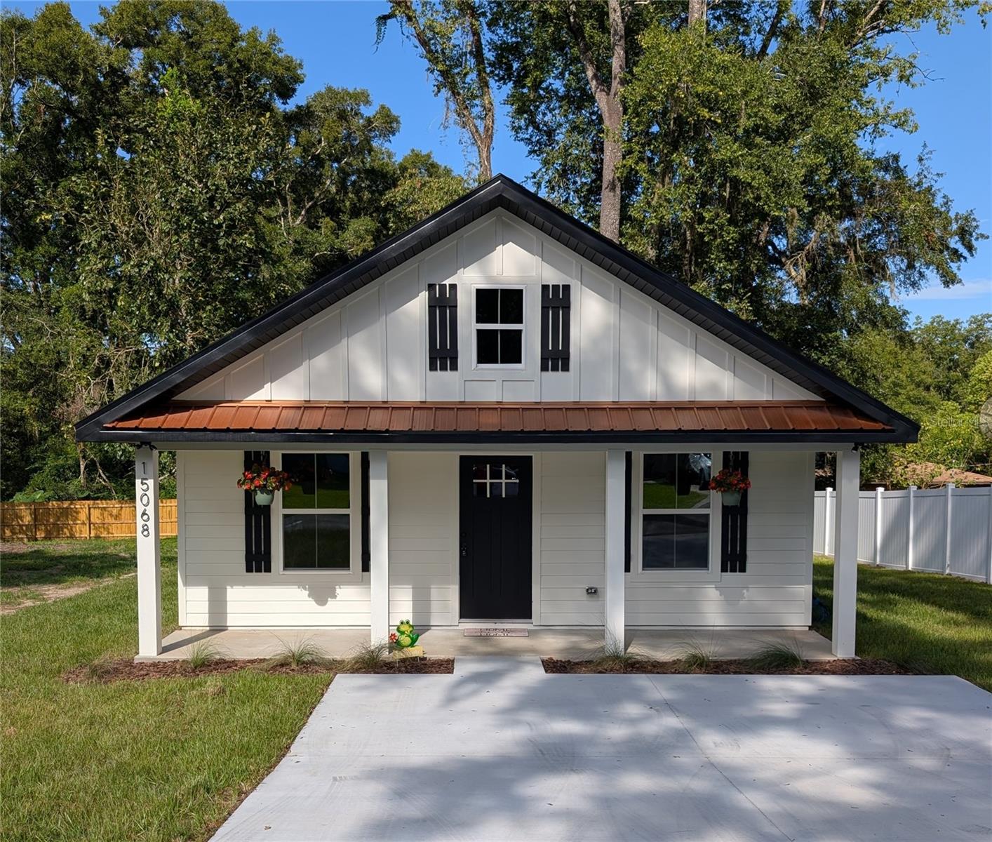 VALUE, VALUE, VALUE. Your brand new home offers exceptional niceties at a great price. The exterior is covered with low maintenance Hardie Board siding with clips where the boards abut. The windows are high efficiency vinyl. A concrete driveway provides ample room for you to park two cars side by side. You will appreciate the covered front porch that extends the width of the house and provides ample room for a bench and rocking chairs. Not to be outdone, the back covered porch looks out over the beautiful extra large lot and a half that is 140 feet deep and has privacy fencing on two sides. French doors with built-in blinds lead out to the covered back porch, making your home perfect for get togethers. Wanna have the game going while out back? No problem. You can mount a TV on a wall in the back porch and plug it right into the internet and power jacks that are installed for such purpose. No cords hanging down! Step inside the front door to waterproof vinyl plank flooring throughout. There is a spacious hallway with bedrooms on either side. A bathroom with a tile shower and quartz vanity is connected to one of the bedrooms and pampers your family or guests. Next comes the great room. Not sure which wall you want to mount your TV on? Again, no problem. Internet and power jacks are on the north, south, and east walls. Furthermore, 2x6 horizontal boards have been placed amongst the studs near the plugs to make mounting easy. You will find such 2x6 horizontal studs in each bedroom including the primary bedroom. Continue through the living room to the island of your dream kitchen. Guests can sit on one side of the island while your pots, pans and utensils reside in convenient cabinets and dovetail constructed drawers and on the other side. Beautiful quartz countertops cover your all wood cabinets. Tile backsplashes, a stainless steel undermount sink and a glass top stove make clean up easy. The microwave, oven, refrigerator with ice maker, and dishwasher are all matching stainless steel from the Frigidaire Gallery Collection. Want to easily charge your phone in the kitchen? An outlet is provided that has USB ports built into it. Open the frosted glass door that reads “Pantry” off of the kitchen and you will find hook ups for your washer and dryer and shelving for your non-perishables. Off the kitchen, the primary suite welcomes you with privacy and a spacious walk in closet. Outlets with built in USB ports make charging your devices on your nightstands easy. Inside the primary bathroom is a large vanity with two sinks nestled on a quartz countertop. Indulge in your walk in shower that not only has two shower heads but two temperature controls. Afraid of running out of hot water? Don’t be. The home has a tankless hot water heater. Your home is heated and cooled by a high quality Carrier HVAC system. There are fans throughout the house. There is no HOA. There are no deed restrictions. 1 year builder warranty included. Need groceries? Hitchcock’s is 1 mile away. Publix is about 2 miles away. A park with a playground is four blocks away. The interstate is less than two miles away. Thereafter, Gainesville is merely one exit south. The listing agent has an interest in the company that owns the house. Schedule a showing today and be impressed with the little things that make this home so special.