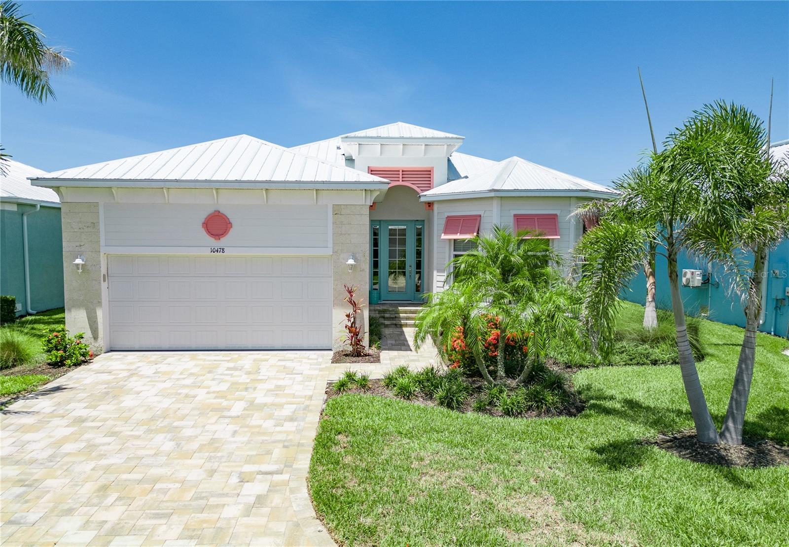 Welcome to 10478 Coquina Ct, a beautifully upgraded 3-bedroom, 2-bath home located in Coral Caye – a rare gated single-family community just minutes from Boca Grande. If you’re looking to enjoy the real Florida lifestyle, this is it. Beaches, boating, and world-class fishing are all close by, and some of the region’s most beautiful natural preserves are just a bike ride away, including Don Pedro Island State Park, Amberjack Environmental Park, and Cedar Point. This solidly constructed block home sits on a stem wall foundation with over 13 feet of elevation – offering peace of mind and structural integrity. Features include metal roof, paver driveway, and impact-rated windows and doors. This home also has an extended garage with high ceilings, perfect for storage. Step inside to a wide-open, light-filled floor plan with upgraded finishes throughout, including recessed ceilings with crown molding, 8-foot doors, floor-to-ceiling cabinetry, stainless steel appliances, and even a wine cooler. Pocket sliders in the great room open up to a covered lanai and private pool area, making this home ideal for entertaining or just relaxing in the sunshine. The Coral Caye community offers resort-style amenities like a clubhouse, pool, gym, pickleball courts, and maintenance-free living with lawn care, reclaimed irrigation, and road upkeep included. Don’t miss your chance to own a like-new, upgraded home in one of the area’s most desirable and unique communities. Schedule your private showing today!