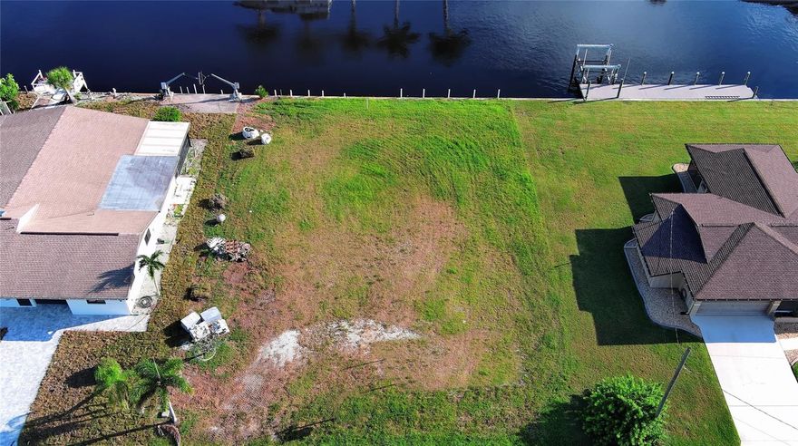 Beautiful Lot 100 x 125 on a deep canal, just 10 minutes to Charlotte Harbor, no bridges. 70ft wide, deep water. Installed in 2001, Manta Ray Seawall brackets by Florida Marine Works. The Canal is 12 miles to the Gulf of America.  Sewer and water connected. A new rec center and pool are being built at the Water's Edge of Harbor Boulevard, with no Association fees. You deserve this. Come and enjoy our paradise! Build your dream home.