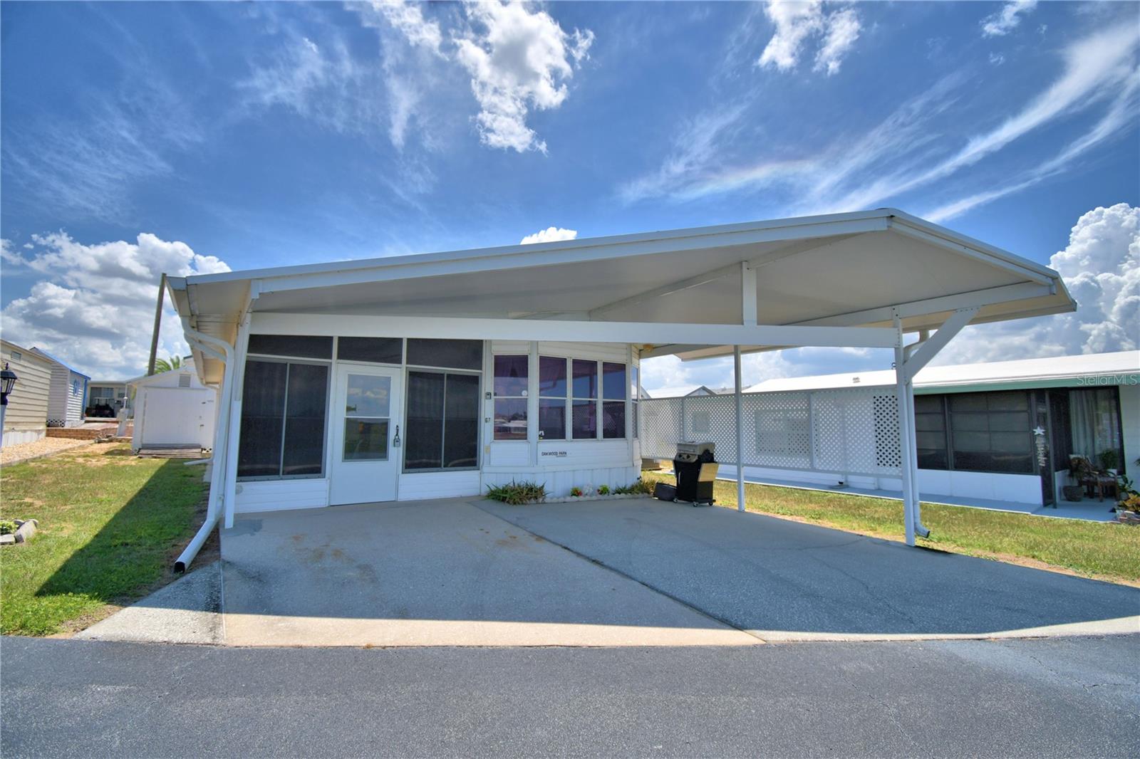 FLORIDA LIFESTYLE AT ITS BEST... GATED 55+COMMUNITY...OWN YOUR LAND...1B/1B POND VIEW HOME facing the west to see some AMAZING Florida Sunsets. FURNISHED well-maintained home with BONUS ROOM, could be utilized as a second bedroom. Inside Laundry Room with washer/dryer. Screen Lanai on back of home as well as a separate standing shed for your additional storage. Newer Membrane/Forever Roof. Covered carport for parking of your golf cart (seller has golf cart/negotiable) and up to 2 vehicles. Enter home through your windowed lanai for your morning coffee outside yet inside. Community offers a Recreational Building, SOLAR Heated POOL, Pickleball Court, Bocce Ball and many, many more amenities and activities provided by the community. Close to restaurants/shopping/medical/major highways leading to our Florida Attractions and EAST/WEST COAST Beaches. Whether Full-Time or Seasonal....YOUR HOME AWAITS YOU. Call Susie today for your private showing.