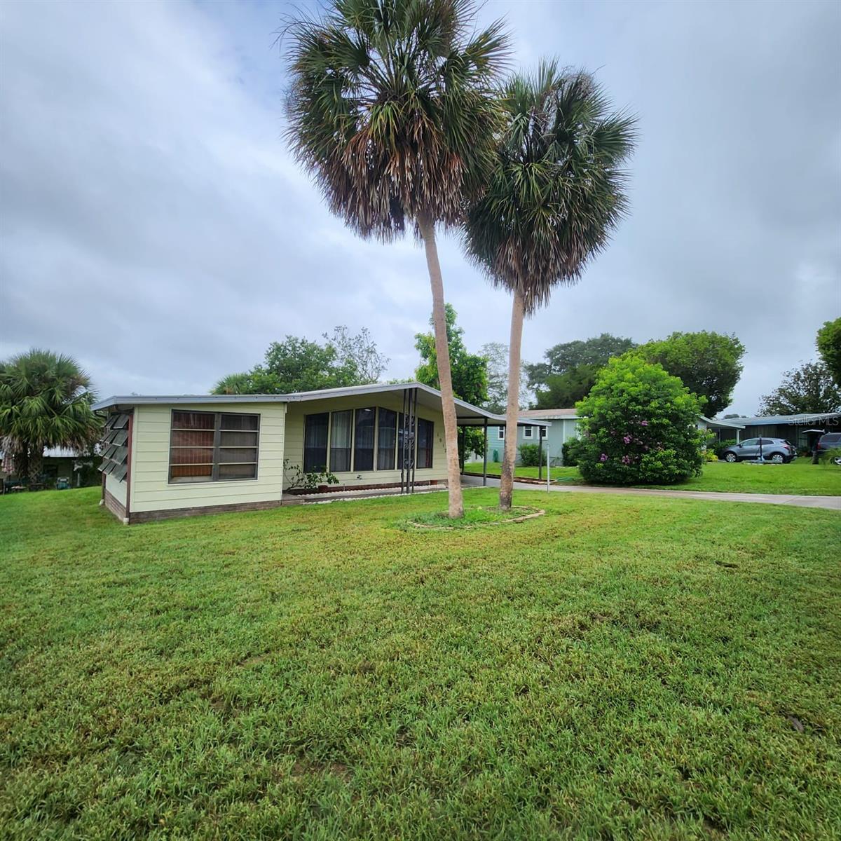 Come take a look at this home located in the GATED neighborhood of Orange Blossom Gardens in Lady Lake/The Villages, Florida. This unique 2/2 OPEN CONCEPT HOME with a long driveway is ready for new memories to be made! Looking for a home with lots of space? Enjoy entertaining friends and family while hanging out in the LARGE FLORIDA ROOM or show off your culinary skills effortlessly by using the kitchen's fun features such as SOLAR TUBE LIGHTING, LOTS OF COUNTER AND CABINET SPACE and the dining room is just a few feet away featuring plenty of built-in shelving for that added character every room needs! The primary bedroom has a LARGE WALK IN CLOSET and the room is large enough to arrange your furnishings how you desire. Before entering the ensuite bathroom, you'll find plenty of space to hold all of your health and beauty products on the built-in makeup counter. This home has an INDOOR LAUNDRY ROOM HOOK-UP AS WELL AS WASHER/DRYER HOOK UP IN THE OUTSIDE STORAGE ROOM! This home is very close to the ORANGE BLOSSOM HILLS COUNTRY CLUB! The monthly fees include access to the recreational facilities, pool, tennis courts and the community park. Orange Blossom Gardens is located just minutes from Spanish Springs Town Square, lots of shopping and dining options and just a short golf cart drive away to the grocery store. No need to drive miles into a community to get to your home. You are in very close proximity to amenities and many major access roads. Schedule a private showing today to appreciate how nice this home actually is!