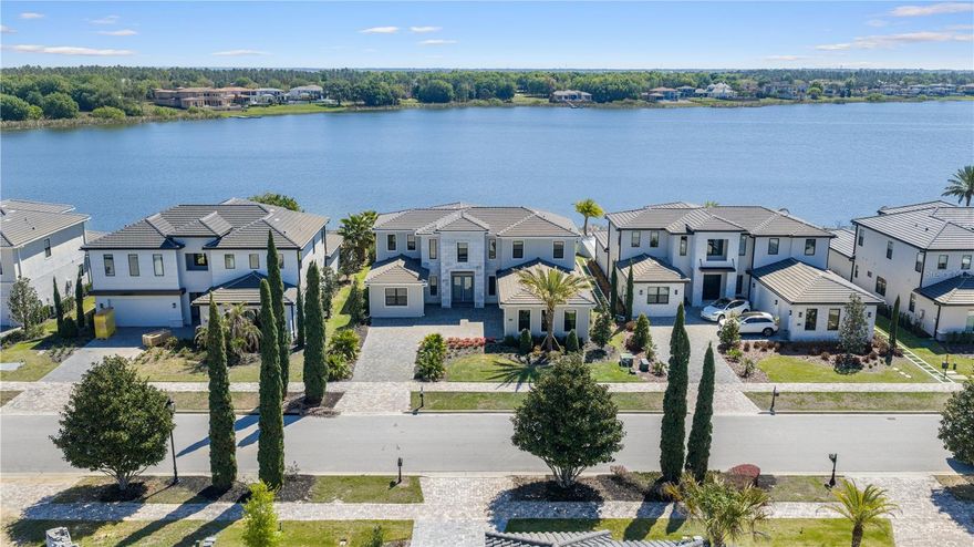 This never-lived-in luxury residence presents an extraordinary opportunity to experience refined resort-style living within the prestigious guard-gated community of Bella Collina. Perfectly positioned along the shores of Lake Siena, this exceptional custom home offers 5 bedrooms, 4 full bathrooms, 1 half bath, and approximately 4,300 square feet of impeccably designed living space, all complemented by breathtaking panoramic lake views and unforgettable sunsets.
Designed to impress, the open-concept floor plan showcases soaring ceilings, and an abundance of natural light that perfectly frame the home’s spectacular water views from nearly every main living area. Elegant designer finishes and thoughtfully curated details create a sophisticated yet welcoming atmosphere throughout.
At the heart of the home, the gourmet chef’s kitchen is a true showpiece, featuring premium appliances, custom cabinetry, a dramatic waterfall island, gas cooktop with full ventilation, and seamless flow into the expansive great room and dining space — all overlooking the stunning lake views.
The luxurious primary suite serves as a private retreat, offering serene water views and a spa-inspired bath complete with a freestanding soaking tub, oversized walk-in shower, dual vanities, and spacious custom walk-in closets.
Additional highlights include a spacious bonus room, luxury flooring throughout, custom upgrades, and an insulated 3-car garage.
Step outside to experience resort-style outdoor living with a heated saltwater pool, covered lanai, WiFi-enabled pool system, and spectacular unobstructed views over Lake Siena, creating the perfect setting for both relaxation and entertaining.
Residents of Bella Collina enjoy world-class amenities including the Nick Faldo-designed championship golf course, resort-style pool, luxury spa, state-of-the-art fitness center, tennis and pickleball courts, fine dining, and an exclusive year-round social lifestyle. Conveniently located near Montverde Academy, upscale shopping, dining, and major highways, this residence embodies the very best of luxury living in Central Florida.