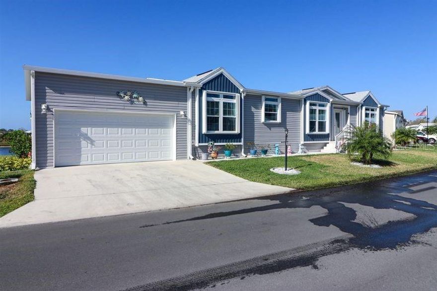 Upon arriving at #136 Keystone located in The Preserve: 12116 SW County Rd 769, Unit #136, Lake Suzy, Fl. 34269 You will notice the Attractive Curb Appeal of this Home. This Charming 2023 Champion/Skyline approx. 1920 sq. ft. Water View & Partially-Furnished Two Bedroom Three Bath Two Car Garage 20x30 Lanai 10x20 is Perfect Place to Relax & Enjoy the many Amenities it Offers! As You enter the Home Bevelled Glass Door leads You to Spacious Living Room Tray Ceilings & Barnwood Oak Luxury Plank Flooring. Split Open Concept Floor Plan. Large Upscale Kitchen with Quartz Countertops, Farmers Sink w/Disposal, Wall Microwave, Flat Top Range with Free Standing Hood& Backsplash All the way up, French Door Refrigerator, Dishwasher, Quartz Top Island with Storage & Easy Close Drawers. Quad Pantry with Barn Door Accent! Rounded Archways lead to Guest Bed Room with Adjoining Bathroom with Shower will accommodate Queen Size or larger Grouping. Hall with Linen. Super Size Bonus Laundry Room with Mop Sink & Alcove Storage leads to Two Car Garage inside entry. Massive Office/Den with Private 3rd Bath Sink & Privy. Primary/Master Bed Room 14x16 will accommodate King Size Grouping Plus Huge Walk-In Closet! Master Bath with Double Size Extra Wide Walk-In Shower accommodates Wheelchair access with seat Rain Head Features! Dual Vanities with Lighted Mirrors, Triple Linen Closet & Private Privy with ADA toilets. Living Room offers Tray Ceilings & Plantation Shelving Window Treatments. French Doors lead to Lanai with  Acryllic Windows additional exit to Backyard Patio for your Water View Oasis! Call TODAY for a Tour!