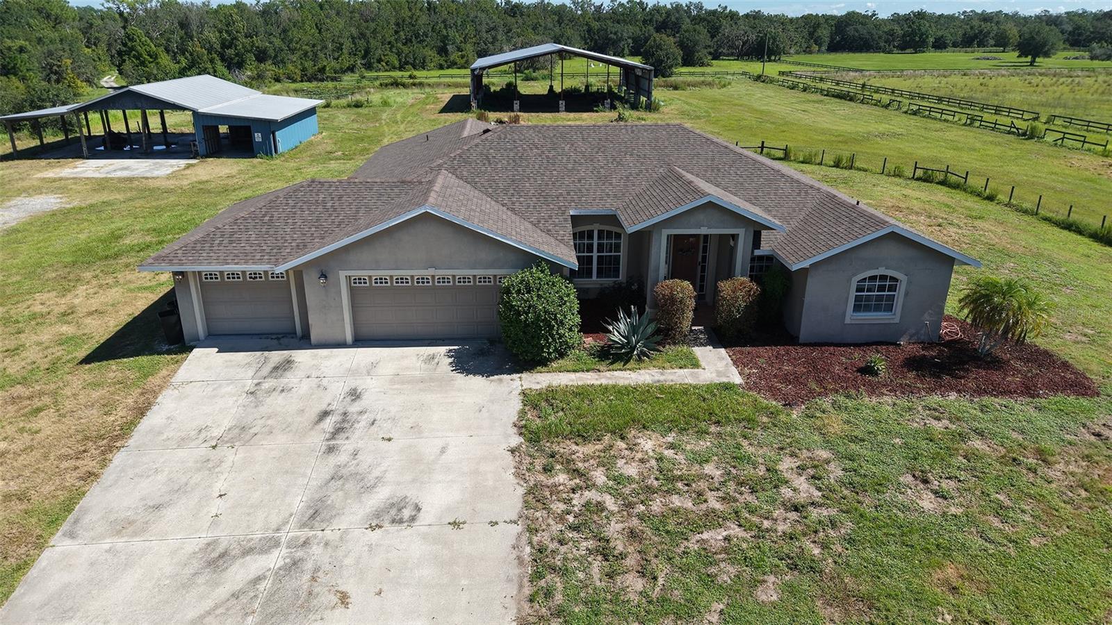 Peaceful 5-Acre Myakka Retreat – No HOA or CDD!
Welcome to your private country escape! This exceptional 5-acre estate offers endless possibilities for those seeking space, freedom, and functionality. Whether you’re bringing horses, livestock, an RV, or all your outdoor toys—this property can handle it all with ease.
Solidly built in 2006, this custom concrete block home offers 3 spacious bedrooms, a dedicated office or potential 4th bedroom, 3 full baths, plus a convenient half bath for guests. The thoughtful split-bedroom layout is perfect for multigenerational living or hosting visitors.
Inside, the open-concept living areas provide flexibility, featuring two separate living rooms—each with sliding doors leading to outdoor entertaining spaces. One opens to a cozy screened lanai for quiet mornings with coffee, while the other opens to an open-air patio with room for a hot tub, fire pit, and barbecues—plus an outdoor shower for after a day on the land.
The kitchen is the heart of the home, boasting wood cabinetry, stone countertops, a butcherblock island, stainless steel appliances, bar seating, and a large breakfast nook separate from the formal dining area. Tall ceilings and ample windows allow natural light to pour in throughout the home.
The primary suite is a true retreat, offering access to the lanai, a spa-like bath with soaking tub, dual vanities, walk-in shower, and a large walk-in closet.
Outside, the property is loaded with extras:
A massive 100x65 metal building ideal for storing equipment, vehicles, or converting into a hobby space
A 63x48 pole barn/workshop, currently used for mixed storage and workspace—easily adaptable to include horse stalls or more
RV hookup
Two picturesque ponds for fishing or watering animals
Open space perfect for gardening, homesteading, or creating your dream mini-ranch
Located in peaceful Myakka City near the Flatford Swamp trail system and community park, you’ll find great schools, including an active agricultural program at the local elementary school. Enjoy rural tranquility while staying connected—just a short drive to I-75, Lakewood Ranch, UTC, Sarasota, and area beaches like Siesta Key and Lido.
There’s nothing quite like this! Schedule your private showing today and imagine the possibilities.
