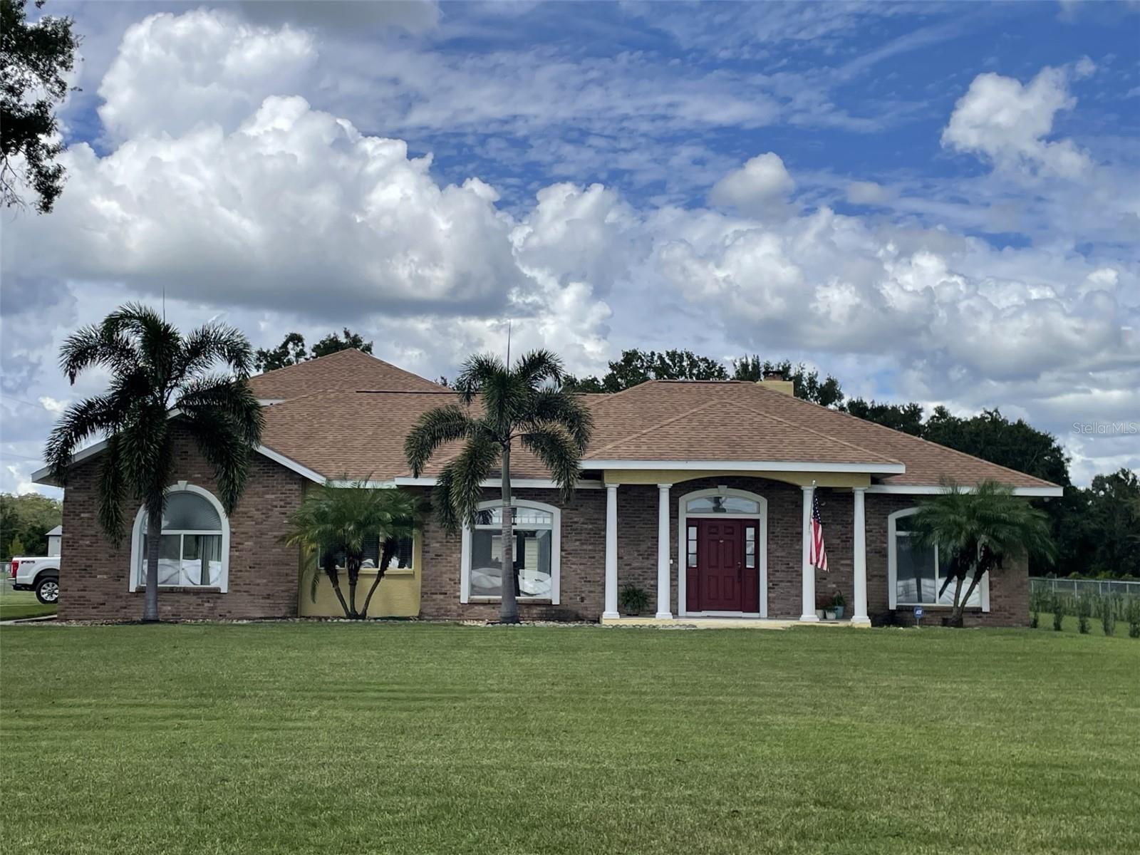 No HOA or CDD. This beautiful one-of-a-kind custom-built home sits on a 1 Acre MOL, with 3 bedrooms 2 bathrooms on the first floor, and a large bonus room/loft on the second level. 2 car side load attached garage with door opener, plus a Detached Garage/Workshop that can Hold Up To 4 Vehicles. Extended Driveway can potentially hold approximately up to 10 cars. New Roof in 2021, Front Porch Tile replaced in 2021. The entire exterior of the home was painted in 2021. The MASSIVE detached garage is 1500 square feet with electric, commercial fans, with 2 roll-up doors (2016). Entering this magnificent home you will find a large open great room, wood burning fireplace, 10 to 12 ft ceilings with lots of natural light, laminate floors, carpet and ceramic tile, semi formal dining room, and an area for a dinette set. The primary bedroom has ample space. Primary bath features a garden tub with water jets and a separate shower and a walking closet. New Well in 2023. The pool has a screened lanai surrounded by decking for your enjoyment and the lighting in the pool has multiple color features. New pavers deck with a firepit in the back yard next to the pool area.