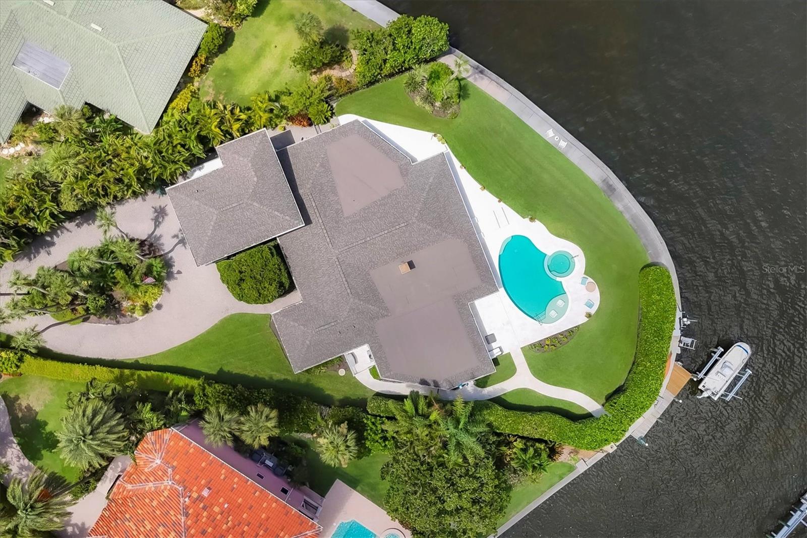 One or more photo(s) has been virtually staged. Welcome to 1701 Sandalwood Drive, a stunning waterfront oasis in sought-after Southpointe Shores, West of the Trail, right on Sarasota Bay. This stunning bayfront lot stretches over half an acre with more than 150 feet of water frontage. Almost limitless possibilities for building your dream home on the bay in a sought-after and convenient location. Enjoy sunsets and quick access by boat to the Gulf via newly opened Midnight Pass between Siesta Key and Casey Key. A rarely available opportunity to construct a new home and enjoy all the Sarasota waterfront lifestyle has to offer. The home has been remediated and is beautiful. Inside, the open and functional floor plan has large tile set diagonally throughout the main living spaces. The living room, featuring a charming brick fireplace, seamlessly blends into the kitchen and dining areas. The kitchen is a chef's dream, complete with wood cabinetry, granite countertops and a top-tier stainless steel appliance package. The family room, with its walls of large windows, provides endless water and sunset views, creating a serene and picturesque living environment. The primary suite is a tranquil escape, offering an updated en-suite bath and an enclosed sunroom. Additionally, there are three guest bedrooms and 2.5 guest baths for added convenience. The second-floor bonus room is a blank slate and could serve as an office, workout space or any number of alternatives. The enclosed patio offers breathtaking views of the sparkling pool, expansive stone pool deck, spacious yard and the bay beyond.