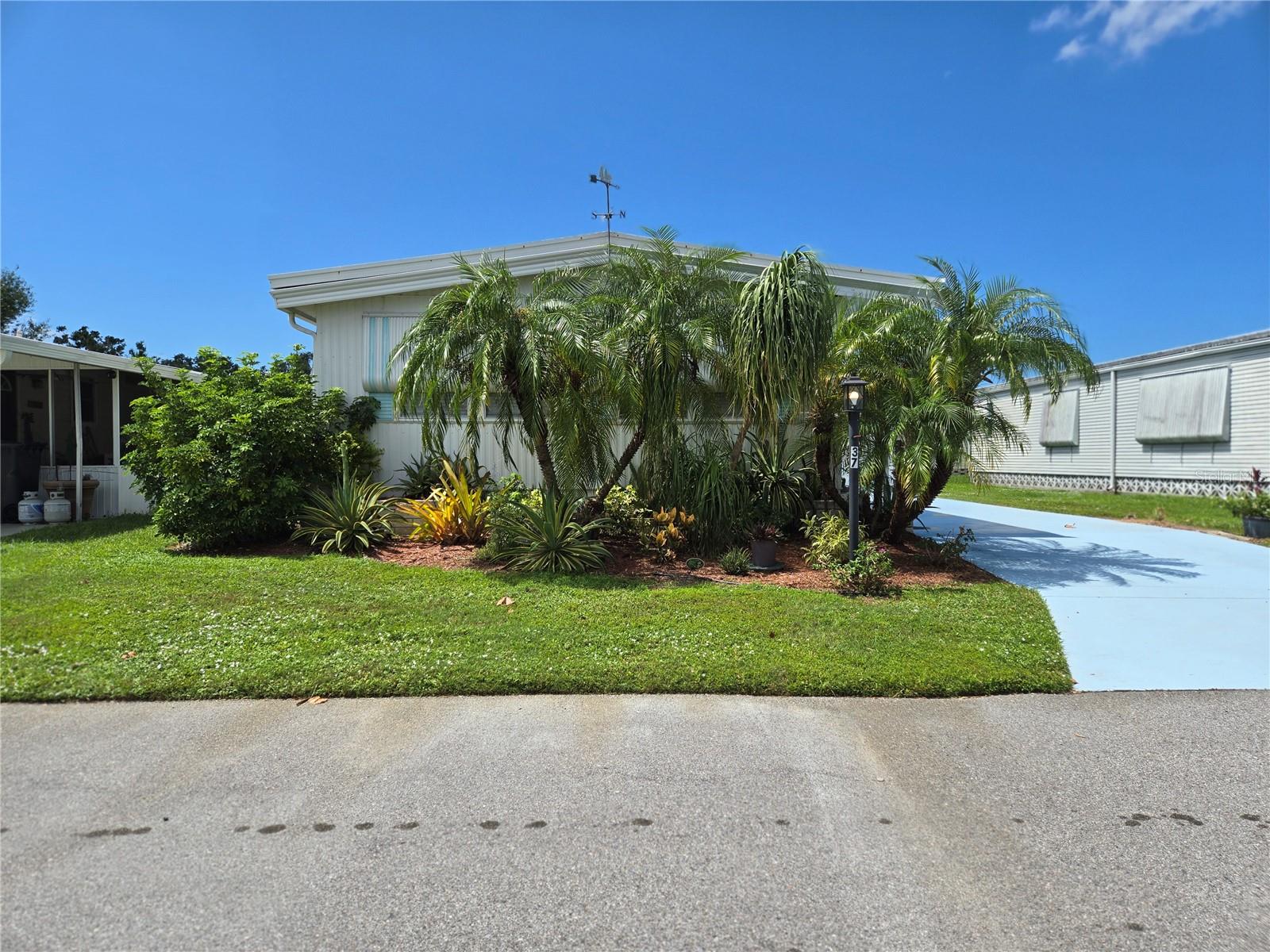 Discover incredible value in this nicely updated and fully furnished 2-bedroom, 2-bathroom home located in the welcoming all-age community of Shadow Brook. Priced to reflect recent storm impact from Hurricane Milton, this property is move-in ready and offers a fantastic opportunity for buyers looking for comfort, space, and convenience. Please note: the attached carport was lost during the storm.
As you step inside, you’ll find a bright and inviting kitchen featuring resurfaced counters, a decorative tile backsplash, and plenty of cabinetry for storage. The open concept living room creates a comfortable gathering space and flows seamlessly into a fully enclosed porch, which adds over 200 square feet of additional living space. This versatile room is thoughtfully furnished with two trundle beds, making it the perfect retreat for overnight guests, or grandkids. The primary bedroom suite offers a private bathroom with an updated granite-topped vanity and a walk-in shower. A spacious guest bedroom with dual closets and built-in storage provides ample room for visitors or family members. The second bathroom has been refreshed with a new vanity, fixtures, and toilet, offering convenience and style.
Other updates throughout the home include subflooring and newer vinyl flooring, giving the space a clean, modern feel. Fully furnished and vacant, this home is ready for its new owner to move in and start enjoying right away. Shadow Brook is a sought-after community offering low quarterly fees that include internet, cable, water, and sewer, along with access to a community pool, clubhouse, and a full calendar of social events. a relaxed lifestyle and a convenient location close to shopping, dining, and the beautiful Gulf beaches. With its updates, furnishings, and flexible living spaces, this property is priced to sell —don’t miss the chance to make it your own!