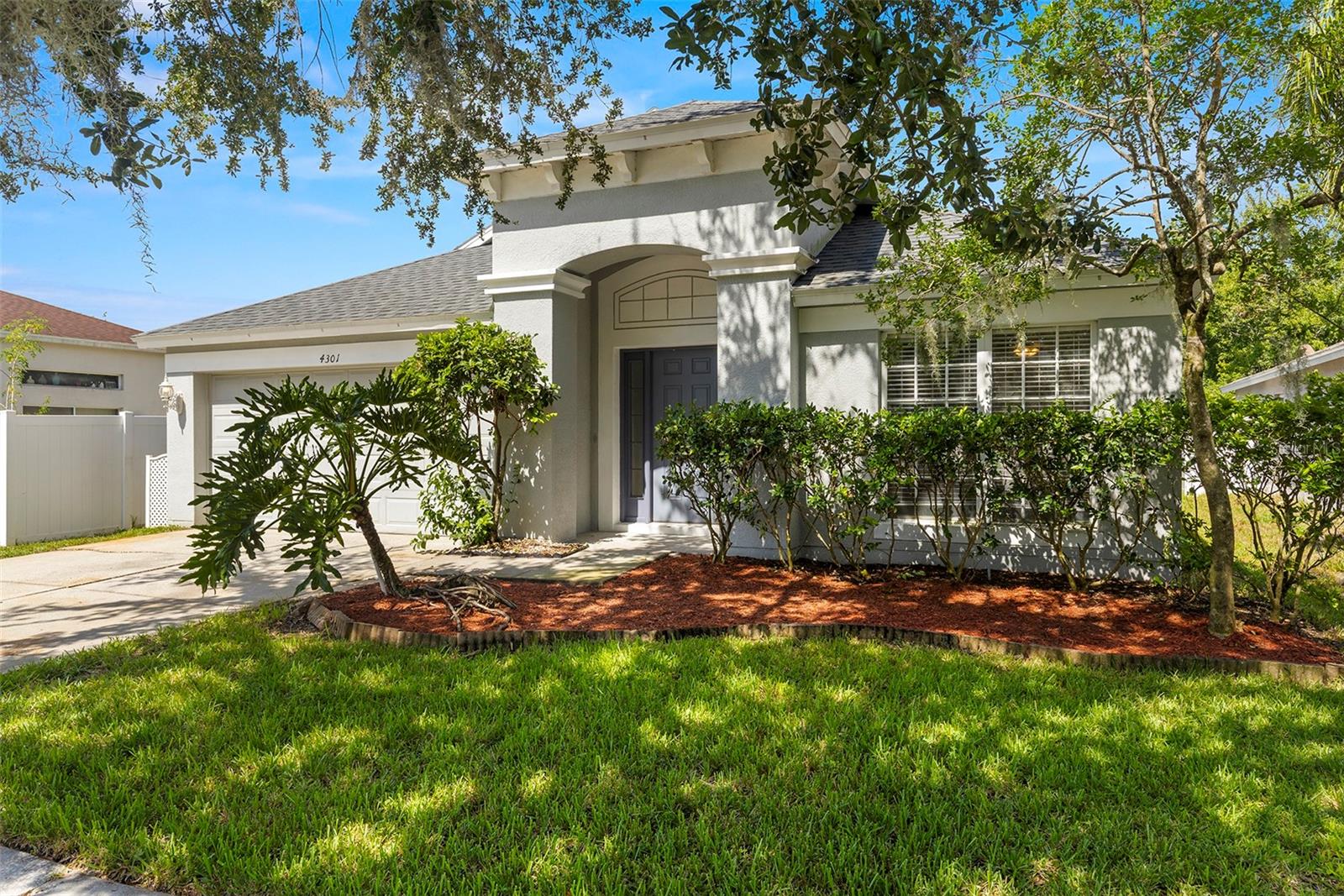 Nestled within the gated community of Oakstead, this beautifully maintained 4-bedroom, 2-bathroom home offers both comfort and convenience. Featuring a spacious open floor plan, the interior is adorned with elegant tile flooring and granite countertops in both the kitchen and bathrooms. The large master suite includes a walk-in closet and garden tub, while the split bedroom layout provides privacy and versatility. Residents enjoy access to top-tier amenities including a resort-style pool, fitness center, playground, basketball courts, and tennis courts. Ideally located near the Veterans Expressway, I-75, premium outlet stores, Wiregrass Mall, and top-rated hospitals, this home delivers an exceptional lifestyle in a sought-after neighborhood.