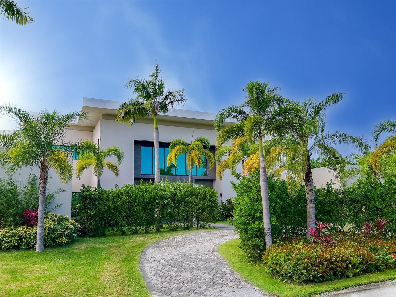 Brand new luxurious contemporary home with 9,500 sqf of air-conditioned living space for the discerning buyer. This architectural masterpiece, designed by renowned architect Jose Garcia, is surrounded by high-end multi-million dollar homes based in the sought after community of Dorado Country Estates, with direct golf cart access to the exclusive Dorado Ritz Carlton Resort.
Inside living includes a great room and massive kitchen/waterfall island which anchors the home, and overlook the gorgeous landscaped gardens. These rooms are complemented by a walk-in pantry, a family room and formal dining room, plus a ground floor guest suite. Luxury, high-end finishes include Subzero and Wolf appliances, European tile, custom Italian cabinetry, Kohler wall hung toilets and fixtures, and is equipped with Trane central air conditioning, a 60kw diesel generator and 1,200 gallon cistern. The Master Suite is a stunning retreat with views of the gardens, an over-sized walk-in Italian closet, walk-in shower, gorgeous tub, and Scavolini vanities! All bedrooms are en-suite with tiled walls and walk-in showers. This beautiful estate consists of 12,000+ sqf construction space and sits harmoniously on a 3,000 sq meter lot (.75 acre). The outdoor living area includes a covered patio and bathroom, and the home boasts two separate garages.