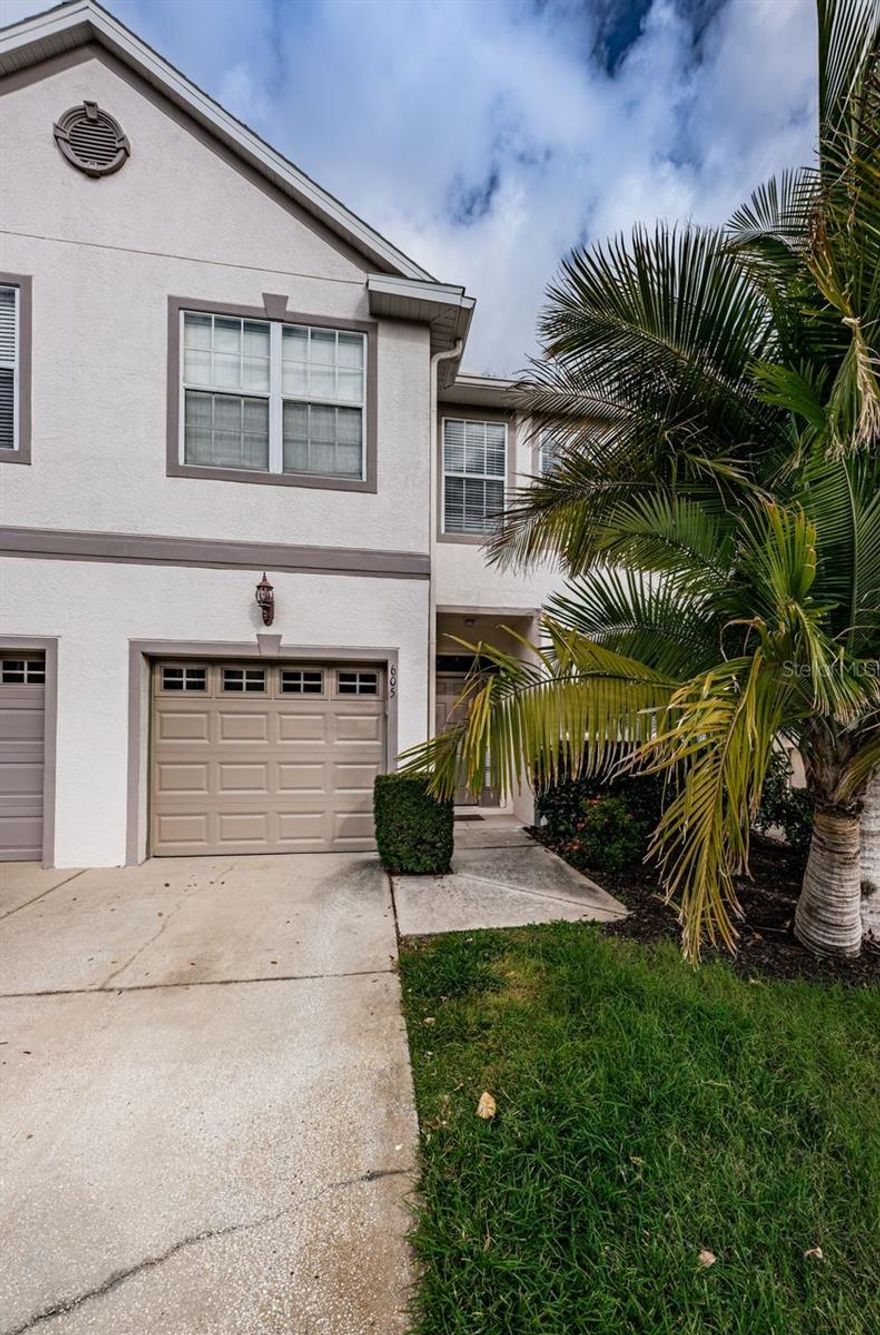Wake up to tranquil lake views and enjoy a low-maintenance Florida lifestyle in this move-in ready townhome located in Wyngate at Brighton Bay. Perfectly positioned with easy access to St. Petersburg, Tampa, and Clearwater, this waterfront home offers both convenience and everyday comfort.

The first floor features a welcoming foyer, a convenient powder room, and an open-concept living and dining area designed for relaxed living and easy entertaining. The kitchen is thoughtfully appointed with stainless steel appliances, bar seating, and a closet pantry, creating a functional space for daily routines and casual gatherings.

Sliding glass doors open to a screened-in lanai and adjacent paver patio, where peaceful lakefront views set the tone for outdoor living. Whether enjoying morning coffee or unwinding in the evening, this private space overlooks the water and surrounding wildlife, including ducks and native birds.

Upstairs, the primary suite features double-door entry, serene lake views, a spacious walk-in closet, and a private en-suite bath with a garden tub and separate shower. Two additional bedrooms share a full hall bath, and the upstairs laundry closet includes a washer and dryer for added convenience.

Additional highlights include an attached one-car garage with built-in cabinet storage, secure interior access, ample guest parking, and a nearby mail center.

Residents of Brighton Bay enjoy resort-style community amenities including a pool and hot tub, sand volleyball court, lighted tennis and basketball courts, and a playground. The HOA covers exterior maintenance, roof, and grounds care, making this an ideal option for buyers seeking a maintenance-free lifestyle.

Waterfront townhomes at this price point are in high demand. Schedule your private showing today and experience lakefront living in Brighton Bay.