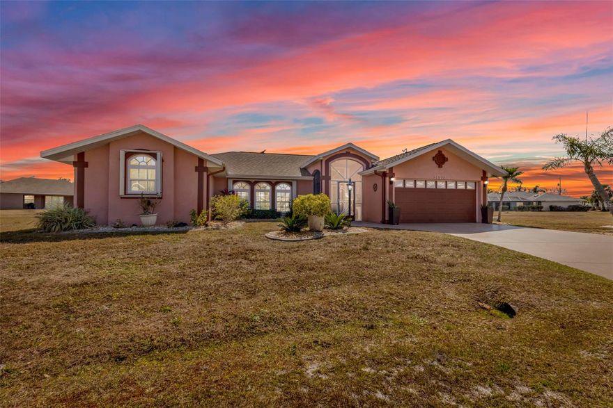 Welcome to 26077 Huanuco Drive in the highly sought-after deed-restricted community of Deep Creek where peace, privacy, and the Florida lifestyle come together beautifully.  Built in 2001, this well-maintained home offers 2,090 square feet of living space and sits on an oversized 21,759 sq. ft. lot. Located on a quiet cul-de-sac and complemented by an additional lot to the right, the property provides rare privacy along with a peaceful greenbelt backdrop. Full hurricane protection is in place, no flood insurance is required, and the home features Manoblock plumbing with a convenient access panel in the laundry room.  A screened front porch welcomes you to elegant impact double front doors that open into a bright and inviting foyer, highlighted by beautiful Tiffany lighting that also enhances the formal living room. The thoughtfully designed floor plan offers a formal living room, formal dining room with sliding glass doors to the pool, and a versatile den complete with tube lighting and a sliding barn door for privacy, is perfect for a home office or flex space.  The spacious kitchen is the heart of the home, featuring a built in china cabinet, stainless steel appliances, a double oven, a center island, a breakfast bar, abundant cabinetry with pull-outs in every cabinet, and a charming dinette area overlooking the lanai and pool—ideal for enjoying your morning coffee. An impact sliding glass door enhances both security and energy efficiency.  The split-bedroom layout provides privacy for owners and guests alike. The guest bedrooms each include walk-in closets, and the guest bathroom offers a sky light and direct access to the pool for seamless indoor-outdoor living.There's a linen closet in the hallway and a pocket slider closes off the guest area for added privacy.  The primary suite is a true retreat, complete with French doors leading to the lanai. The en-suite bath features a Roman shower, relaxing garden tub, dual vanities with separate sinks, and a large linen closet for additional storage.  The laundry room is both functional and bright, offering a skylight for natural light, full-size washer and dryer, built-in cabinetry, a stainless steel sink, and a storage closet.  Step outside to your private backyard oasis. The expansive screened lanai surrounds the resurfaced pool (2022), which features a beautiful lighted fountain. The outdoor living space also includes a built-in kitchen with JennAir range, sink, and refrigerator, plus an outdoor shower and a detached workshop at the rear of the property—perfect for hobbies, storage, or projects.  With new windows, thoughtful upgrades throughout, generous space, added privacy, and a prime location in one of Punta Gorda’s most desirable communities, this home truly checks all the boxes. The attic has two solar fans to save on energy cost. The workshop and the garage have AC/heat!! Make an appointment today to see this stunning home.