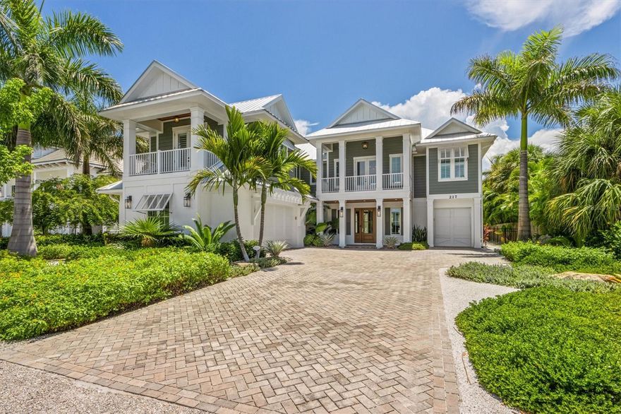 Custom waterfront residence just a short walk to the Gulf of Mexico beaches. This home features 4 bedrooms all with spacious en suite baths, half bath off the living area, custom cabinetry, quartz counters, gas fireplace, wood beam detail in the great room, wood flooring throughout, elevator, impact windows and doors. The kitchen, open to the great room offers a stand alone island, breakfast nook, Thermador appliances, double refrigerators and a 6 burner gas stove. Across from the kitchen is a wet bar with wine refrigerator. Enjoy palm tree lined views from multiple vantage points in the great room and kitchen that offers lots of natural light. The master suite has a private balcony with water views, walk in closet and a rich master bath with free standing tub, walk in glass shower and double vanity. The main guest suite is a wing of its own with a private covered porch, coffee bar with beverage refrigerator, walk in closet and a walk in glass shower. The travertine lined outdoors is the wow factor of this home with spacious outdoor living and dining areas that surround the impressive free form heated pool and spa with cocktail table and sun shelf. Deep water dockage, outdoor shower, 2 car side entry garage along with a separate 1 car garage for your golf cart and all the toys. Experience the ultimate waterfront living in your new piece of paradise!