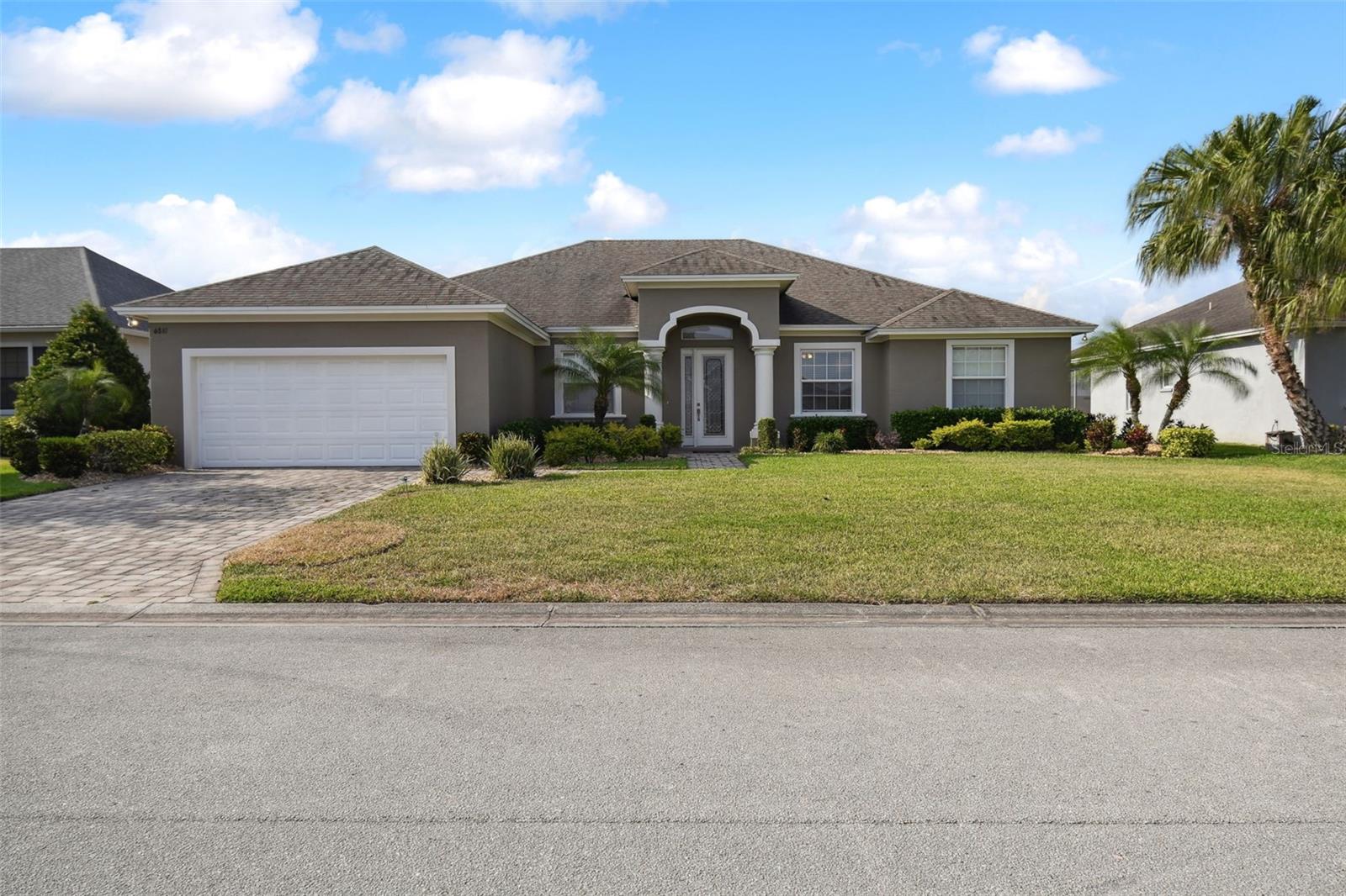 Welcome to this 4 Bedroom, 3 bath home. This home features wood cabinets, granite counter tops throughout, crown molding, garden tub, his and hers vanities, a covered lanai, brick pavers for driveway, walkway and lanai, and energy efficient features. Great South Lakeland subdivision in excellent school district.